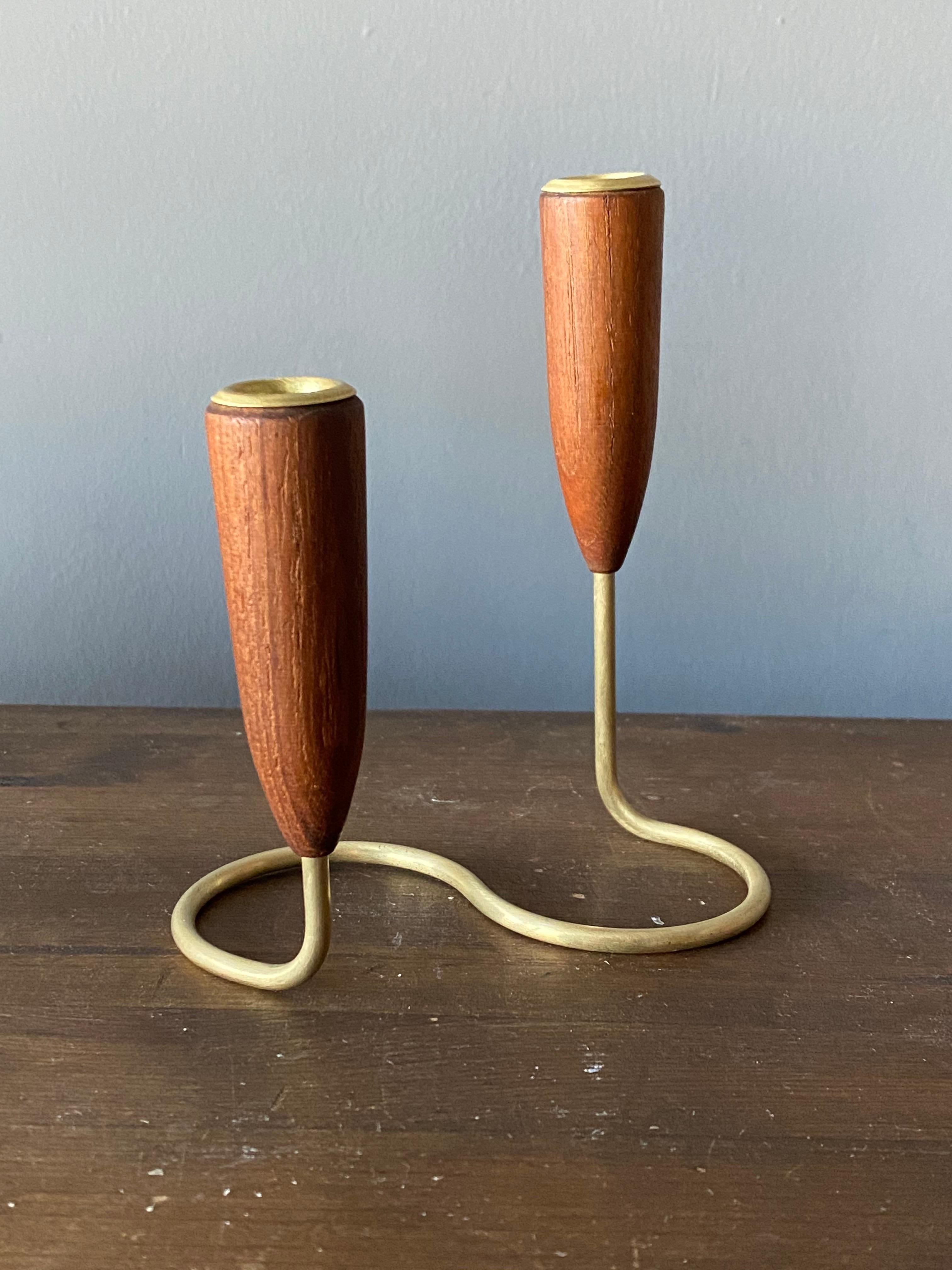 A small organic candelabra / candleholder, in brass and solid teak, Denmark, 1950s.

Other designers of the period include Piet Hein, Paavo Tynell, Josef Frank, and Jean Royère.

          