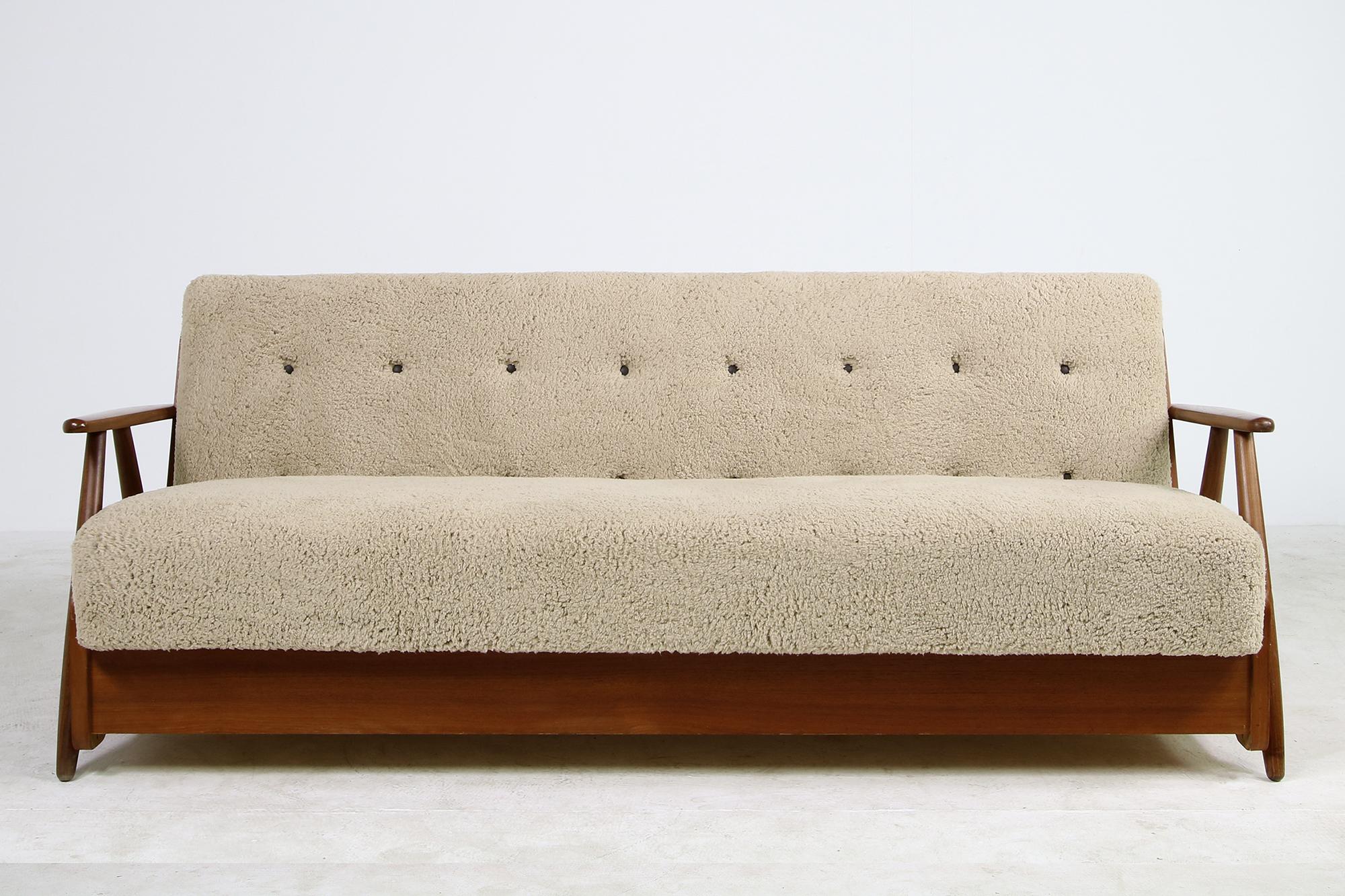 Beautiful authentic midcentury sofa. from the early 1950s made in Denmark, reupholstered, covered with great teddy fur fabric, like sheepskin, but softer to the touch, super cozy, tufted with brown leather buttons, the sofa has beechwood legs and