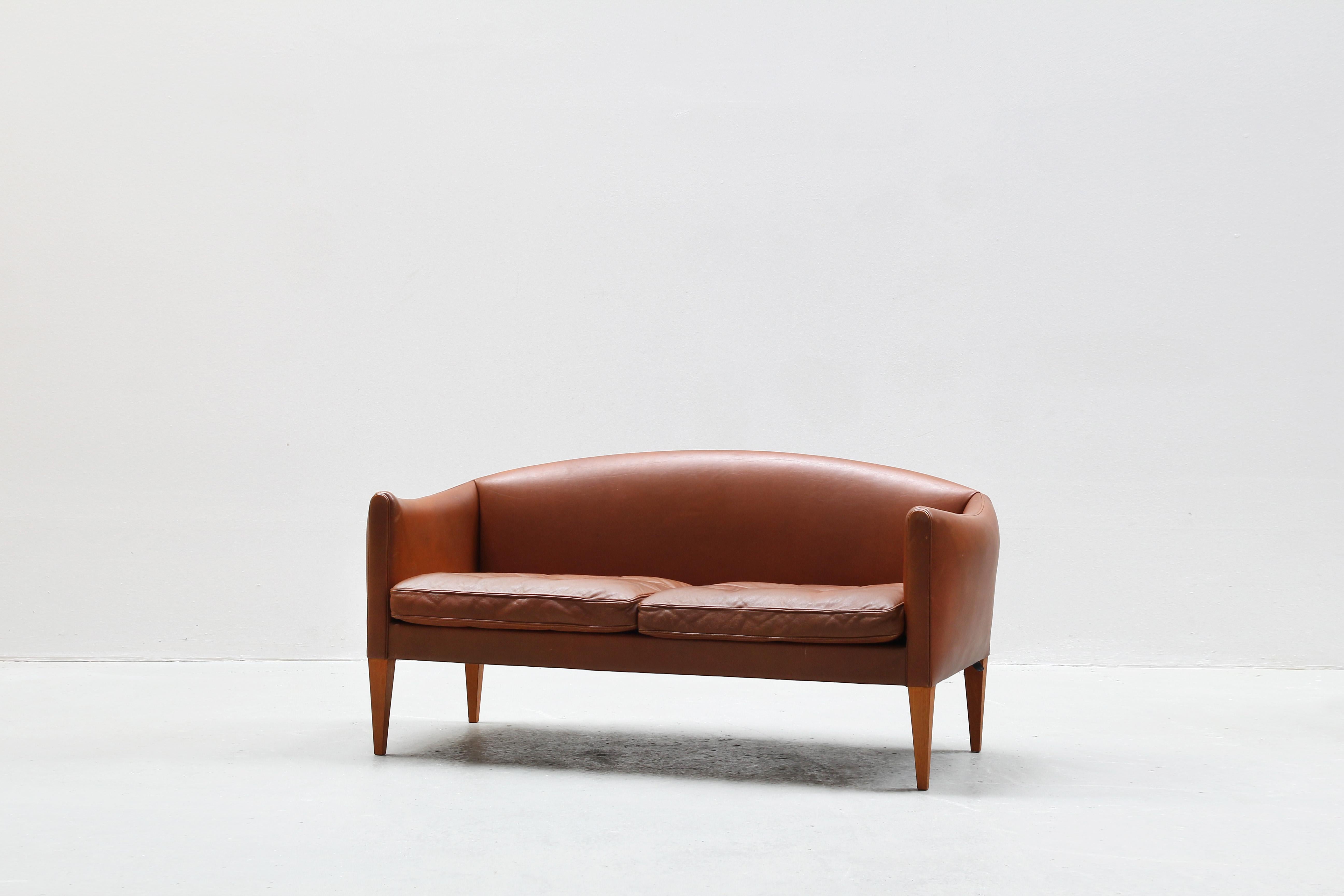 Very beautiful two-seat sofa designed by Illum Wikkelsø and produced by Holger Christiansen in the 1960s in Denmark.
The sofa is in an great original condition with just little traces of usage.