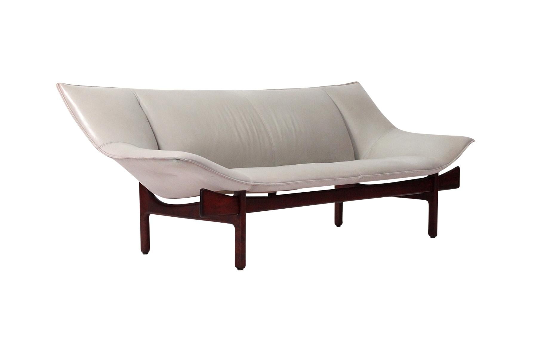 Beautiful leather 3-seat sofa by O&M Design. This design blends Japanese and Scandinavian design aesthetics bringing traditional shapes into a modern context. The base frame is modeled on the design of Torii temple entrance gates. Manufactured by