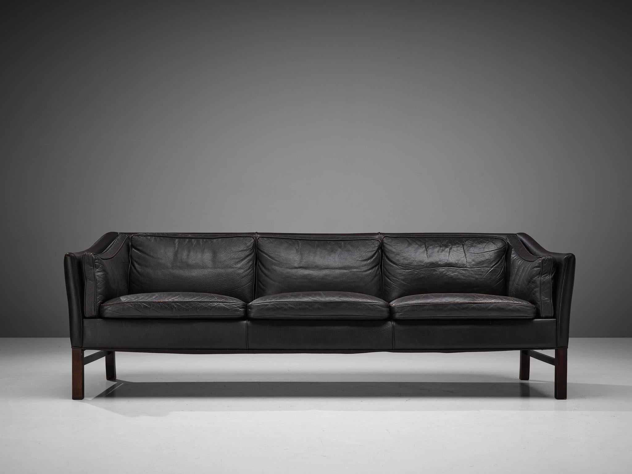 Sofa, leather, stained wood, Denmark, 1960s

This classic sofa of Danish origin features modest and subtle lines and shapes that emphasize the clear construction of the design. The sofa rests on a well-proportioned base that lifts the sofa up