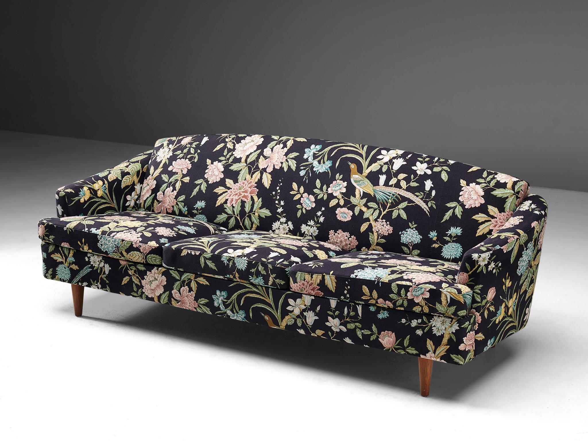 Three seat sofa, floral upholstery, teak, Denmark, 1960s

Three-seat sofa with rounded backrest. This sofa is upholstered in a vibrant floral upholstery with a black background color. The fabric displays different flowers and birds across the