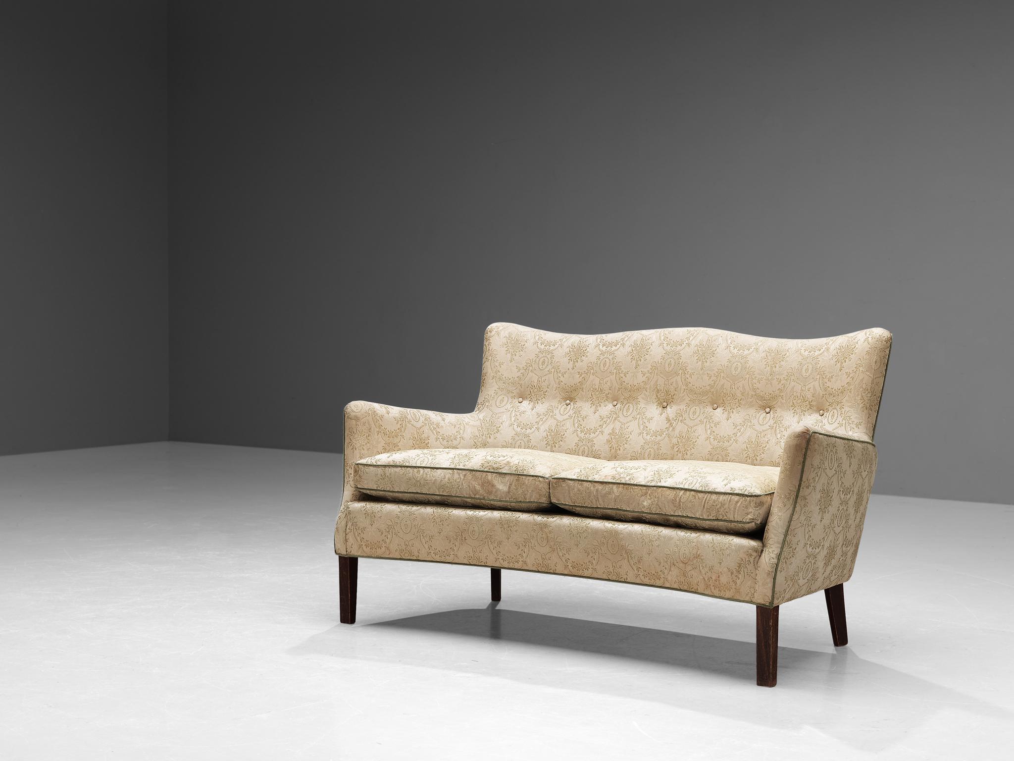 Sofa, fabric, wood, Denmark, 1950s.

This sofa has all the flair and vitality of a typical Danish mid-century furniture piece. This particular design invites you to spend more time on it due to its imposing, high backrest which is slightly tilted. A