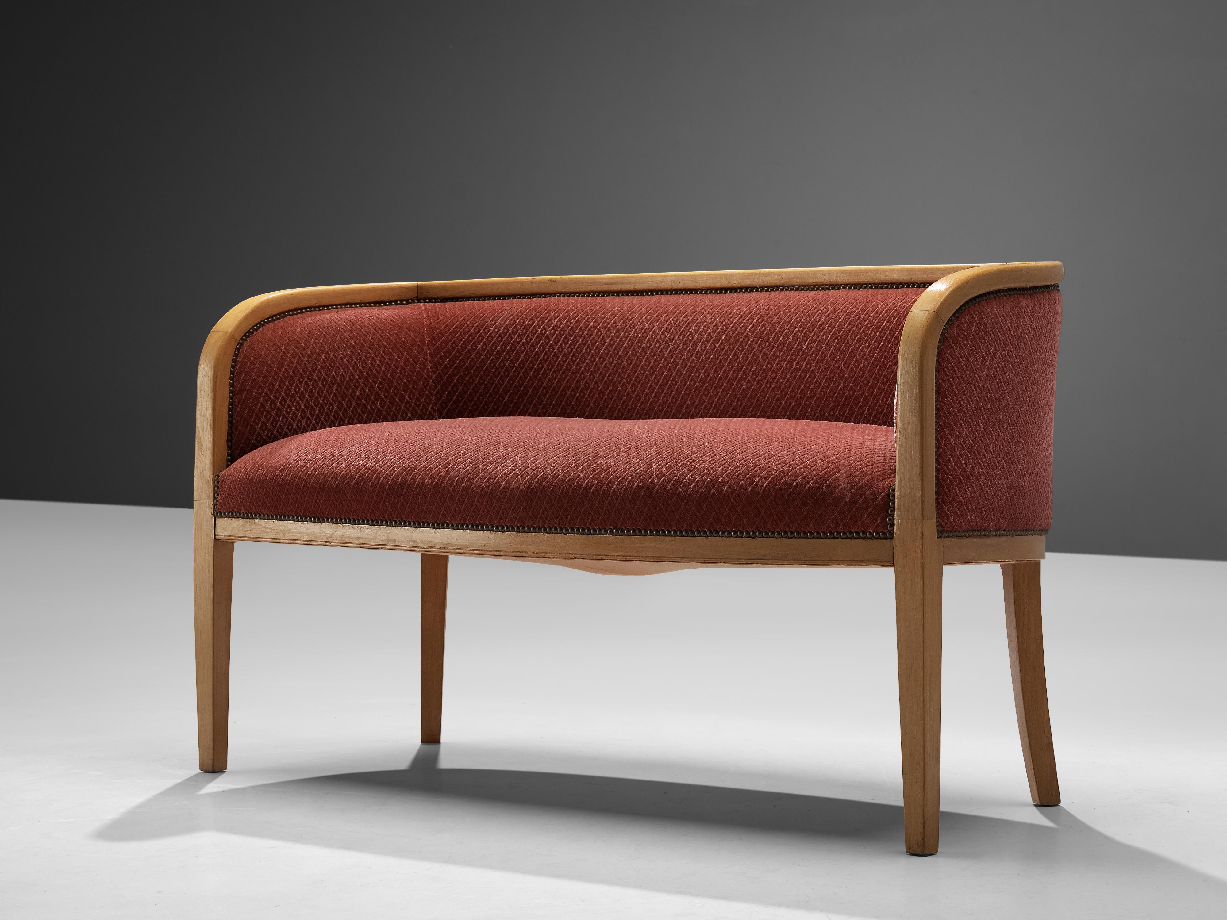 Sofa, fabric, brass, beech, Denmark, 1950s

A bright frame in beech wood curves around the seat and backrest. Both are upholstered in a soft pink fabric that is attached to the frame with brass nails. From the back, the sofa is showing the same kind