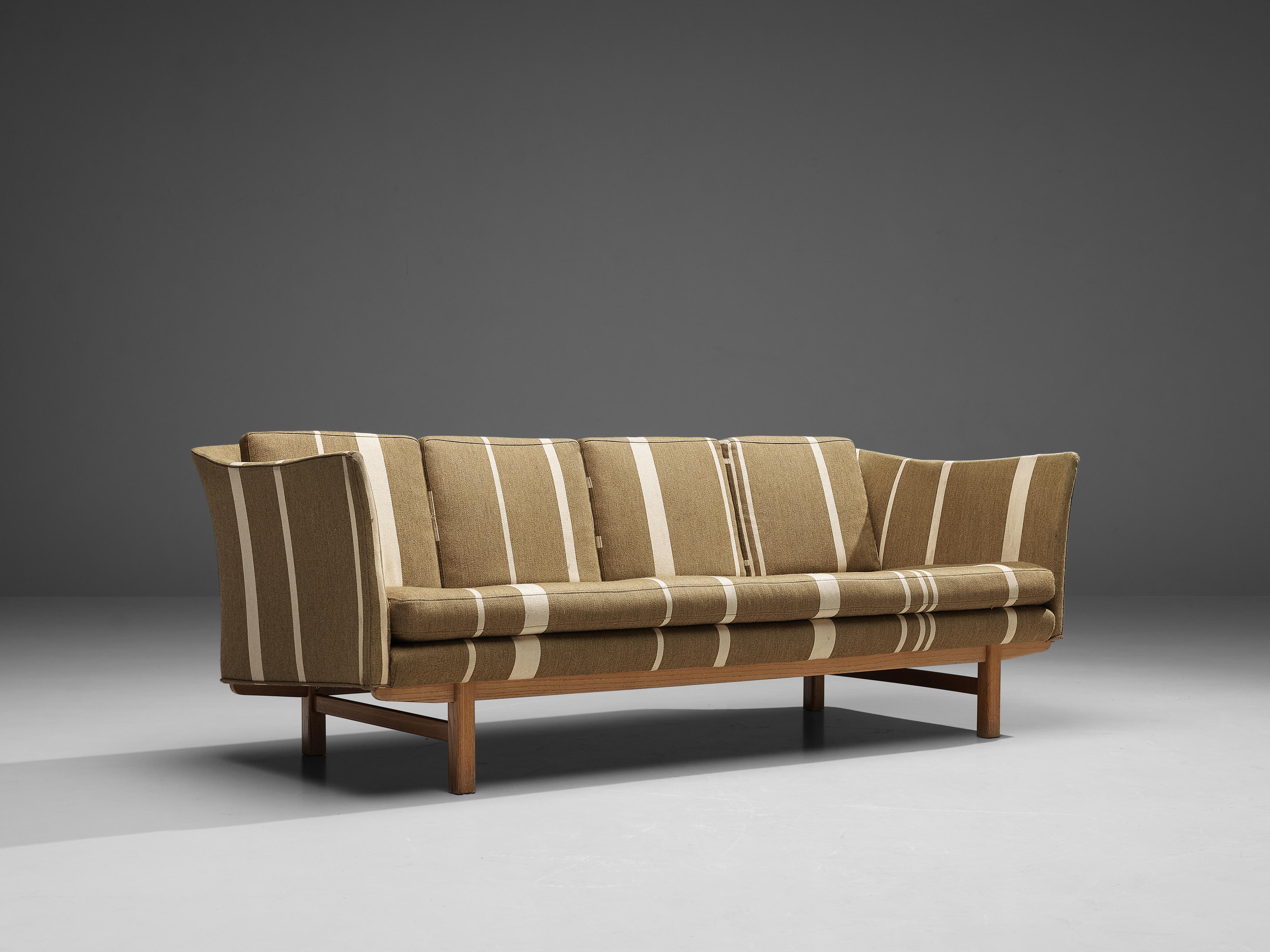Sofa, fabric, wood, Denmark, 1950s

This sofa of Danish origin features modest and subtle lines and shapes that emphasize the clear construction of the design. The armrests are slightly positioned outwards, which contributes to the sofa's open