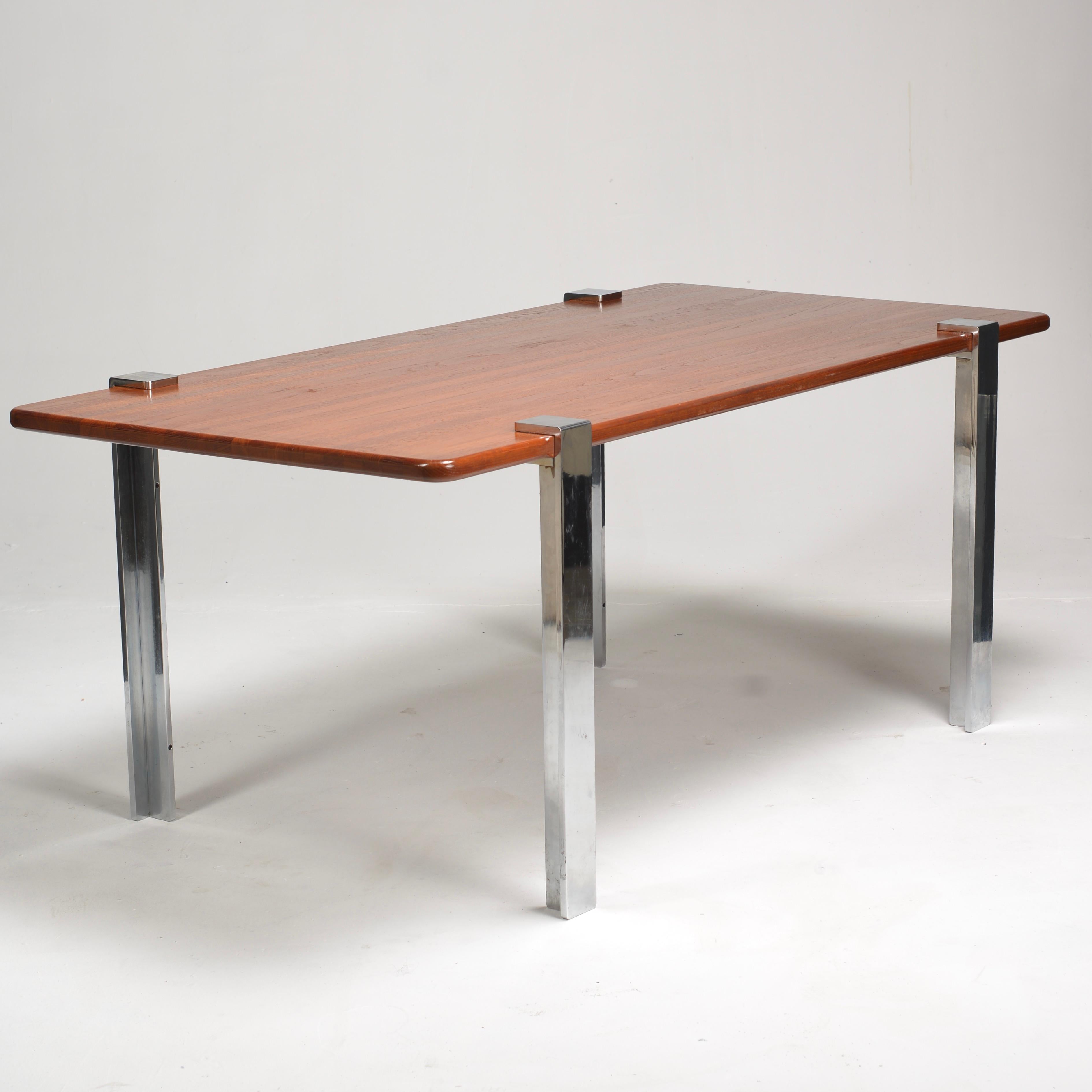 Solid teak table with chrome legs.