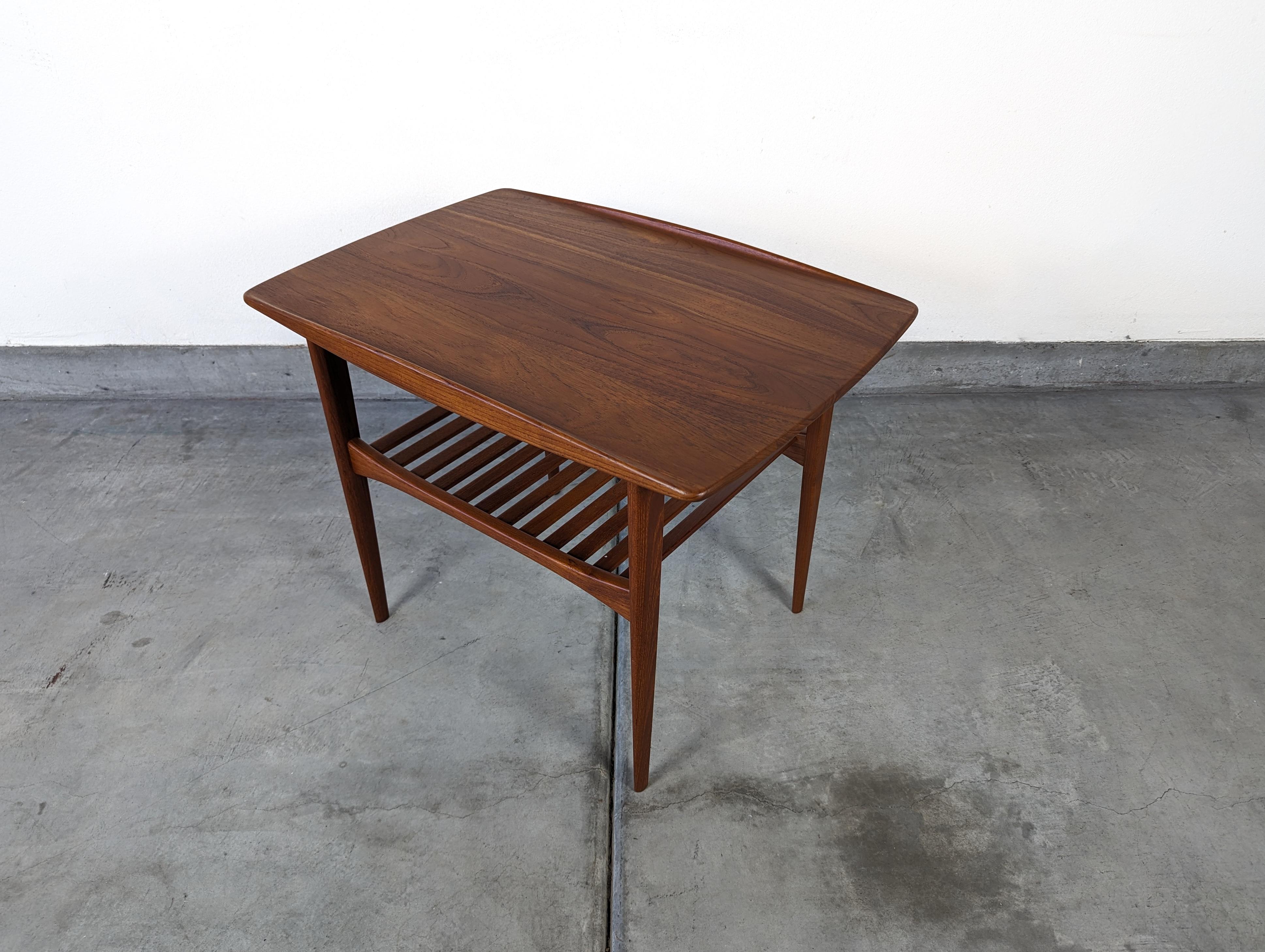 Step into a realm of timeless elegance with this exquisite vintage mid-century modern Teak Coffee Table, a testament to the visionary prowess of renowned Danish designer, Finn Juhl. Designed in the 1950s for France and Son, a company well-known for
