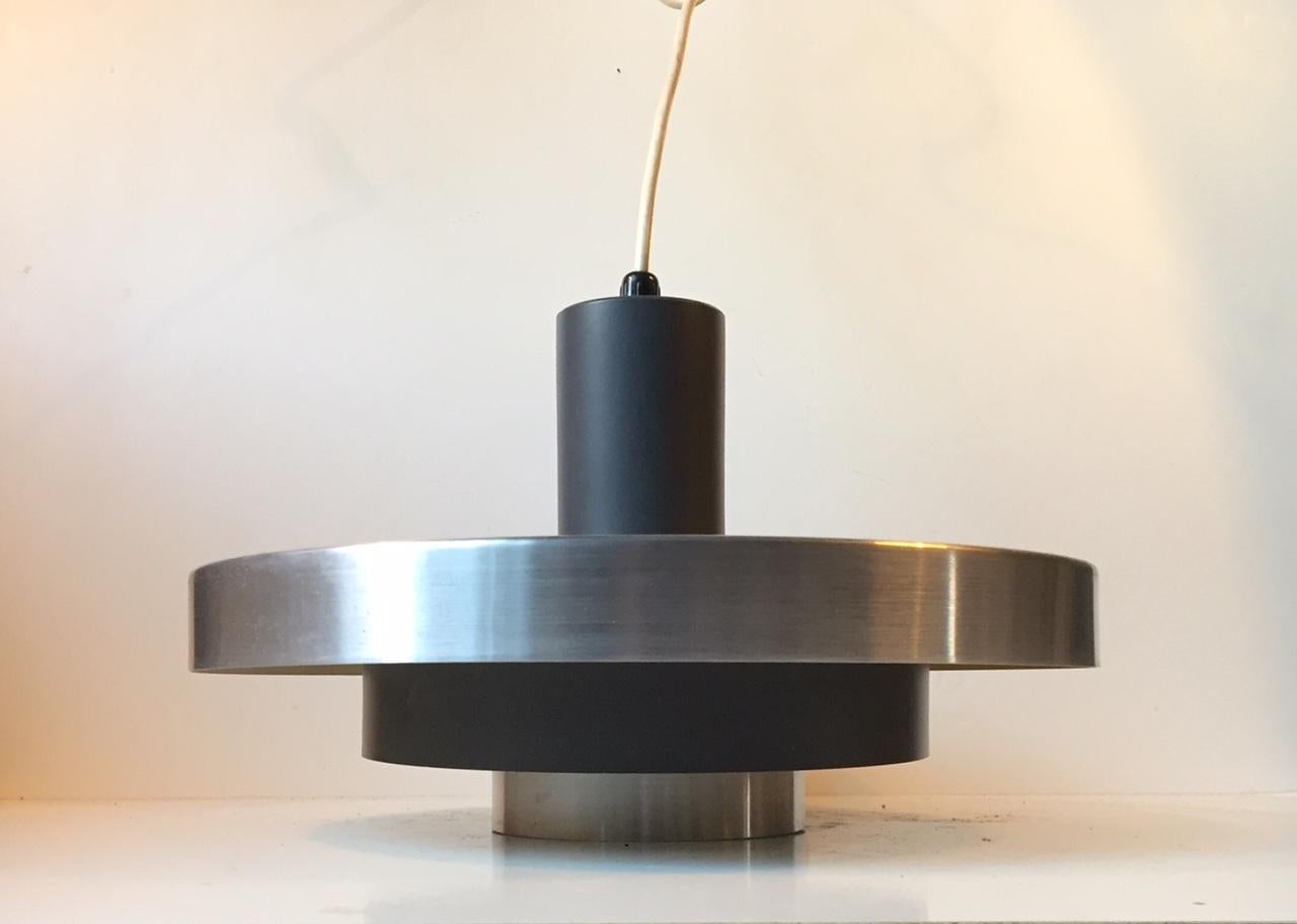 This three-tiered Danish ceiling lamp was manufactured by Fog & Mørup in Denmark during the 1960s in a style reminiscent of Stilnovo. It is made from brushed aluminium and partially lacquered grey. The shades are held in place by three brass balls.