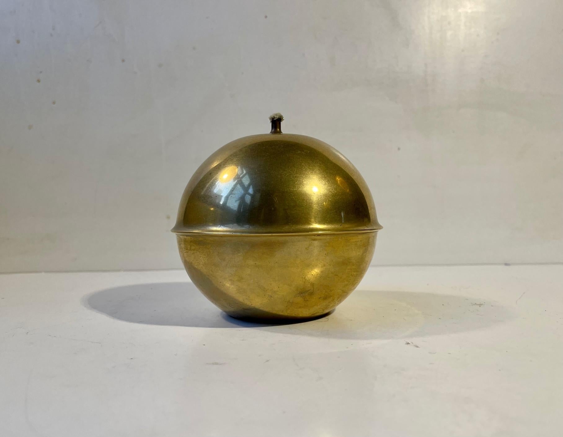 A spherical oil lamp in brass. Commonly called a Planet Light here in Denmark. Anonymously made in Denmark circa 1960-70 in a style reminiscent of Henning Koppel and Hans Agne Jakobsson. Measurements: H: 13 cm, Diameter: 13 cm.
