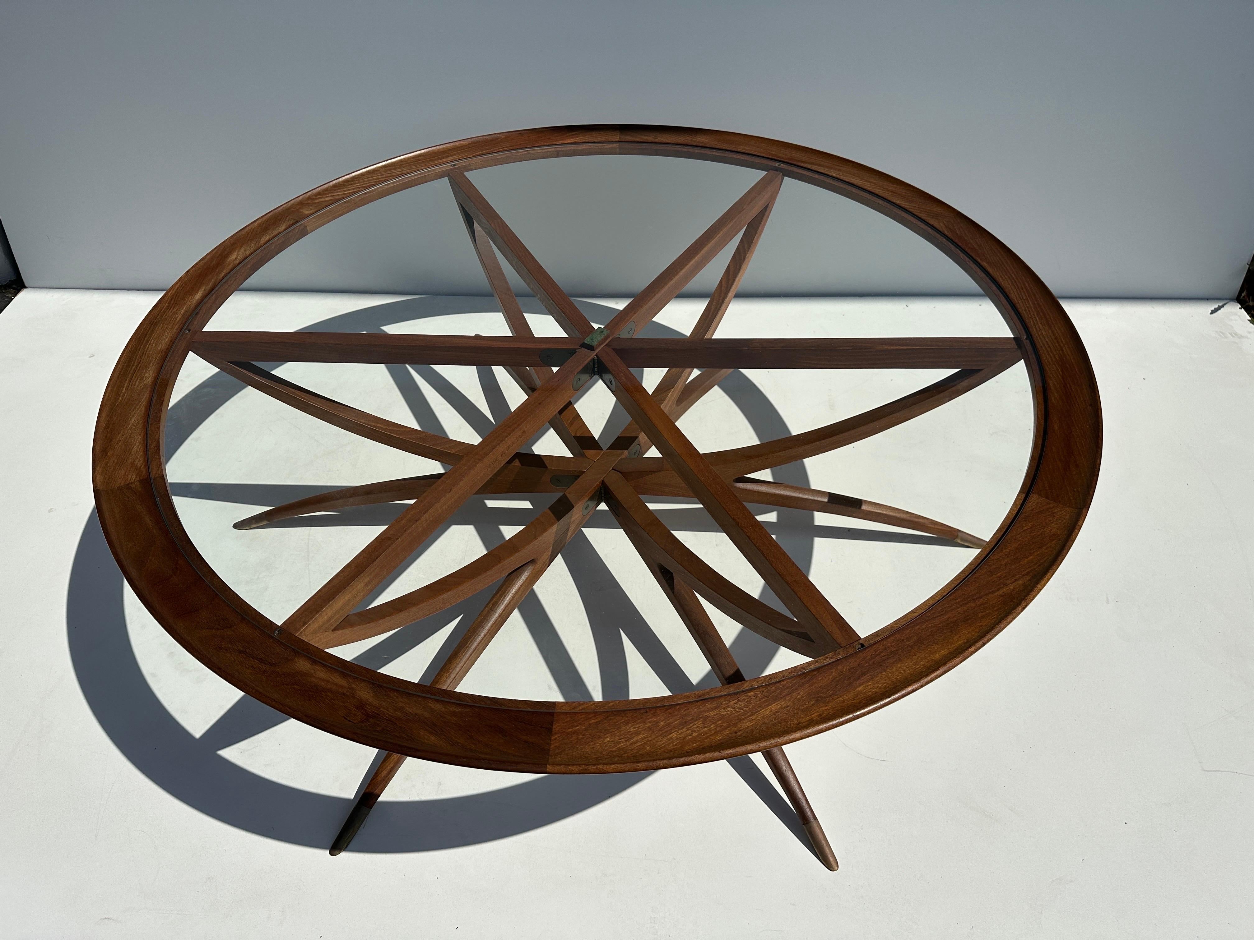 Danish teak spider leg coffee table with clear glass top and patinated brass sabot legs. Base folds for easy transportation and storage.
Similar to designs by Ico Parisi and Vladimir Kagan.