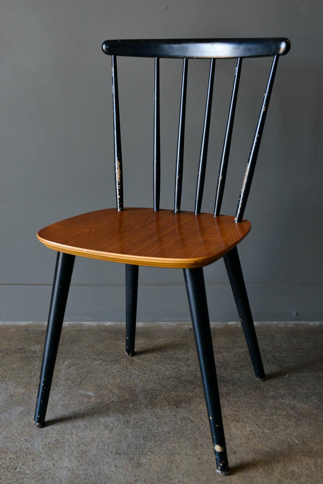 Danish spindle back chair by Thomas Harlev for Farstrup, 1960. Single dining chair with age appropriate wear but in good condition. Two tone black frame and legs with teak seat. 

Measures 18