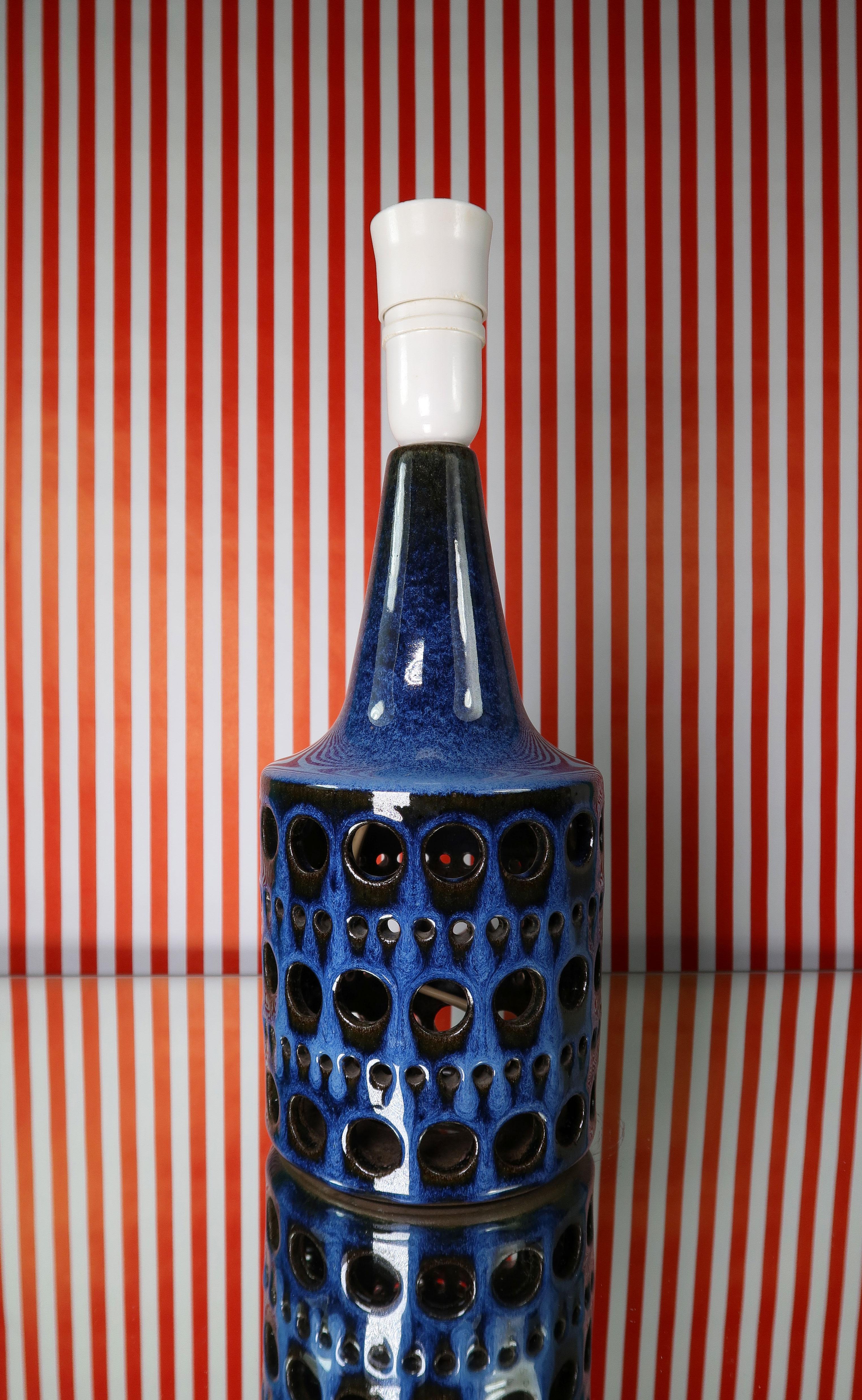 Extraordinary Danish Mid-Century Modern handmade ceramic table lamp by Marianne Starck for Michael Andersen & Son in the 1960s. Shiny indigo blue, light blue and black running glaze with geometric pattern of circle shaped perforations in two