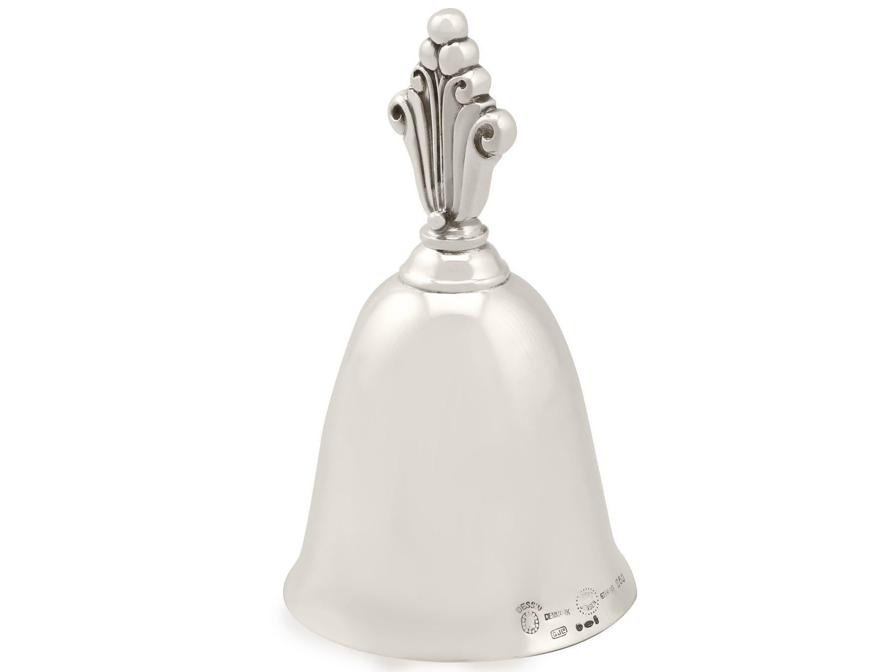 An exceptional, fine and impressive vintage Danish sterling silver table bell made by Georg Jensen; an addition to our range of ornamental silverware.

This exceptional vintage Danish sterling silver table bell has a plain bell shaped form.

The