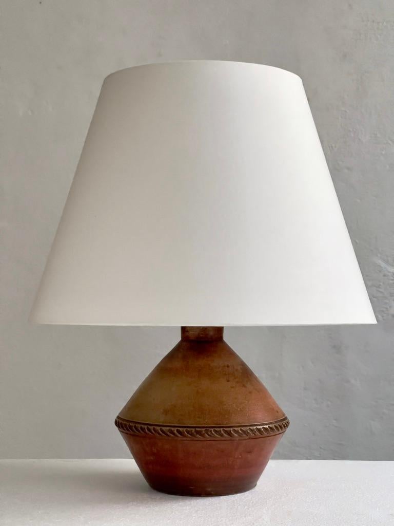Danish stoneware table lamp with an earthy red brown glaze. 
Denmark 1930s.

(The lamp will be rewired with a fabric wire, new socket and new 110v or 220v plug before shipping)

This original Danish stoneware table lamp, a rare gem from the 1930s,