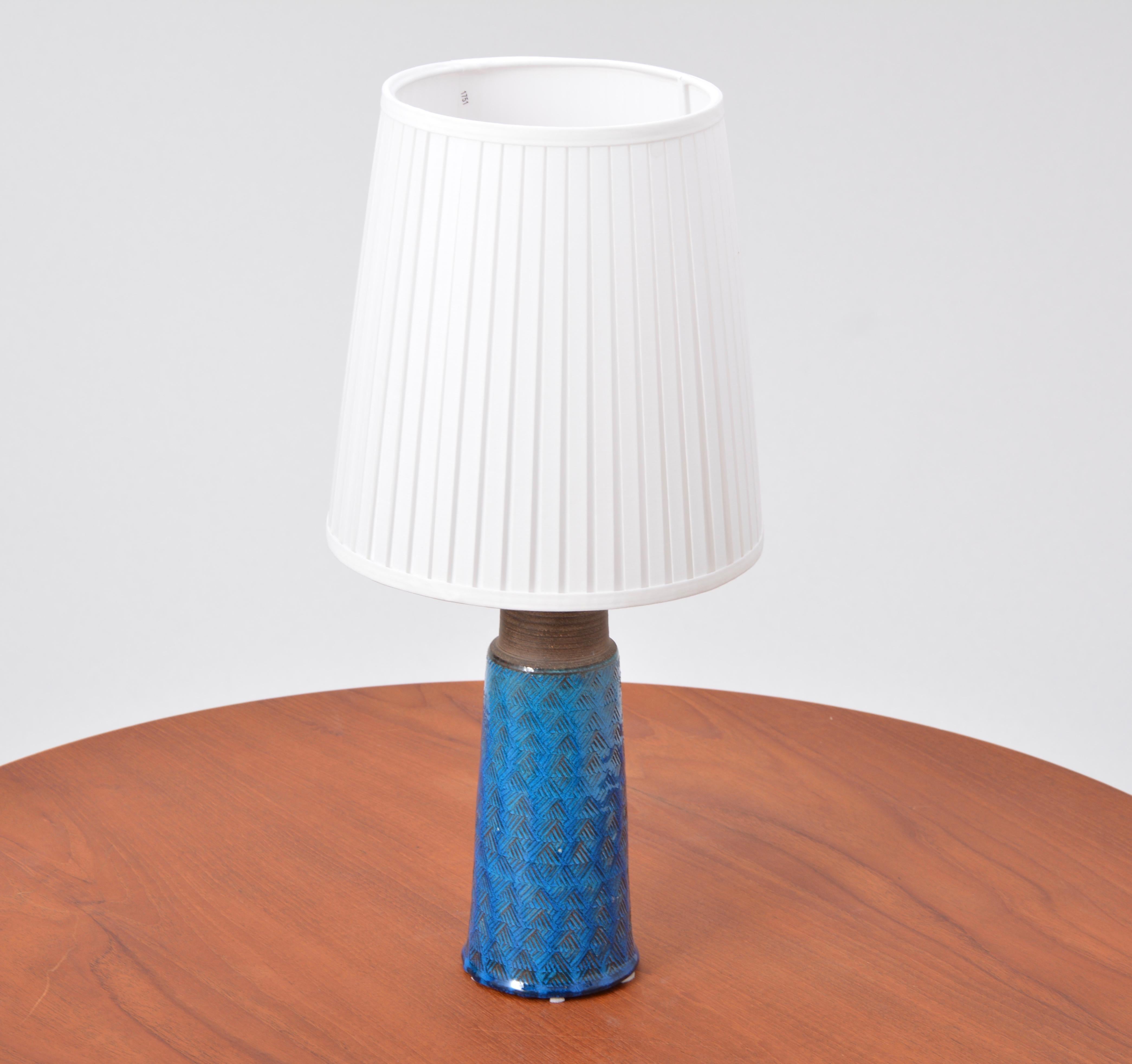 Turquoise Danish Mid-Century Modern Stoneware table lamp by Nils Kähler

This stoneware table lamp was designed by Nils Kähler and made in the 1960s by Herman A Kähler Ceramic (HAK) in Denmark. It has a turqouise colored glaze covering. The top is