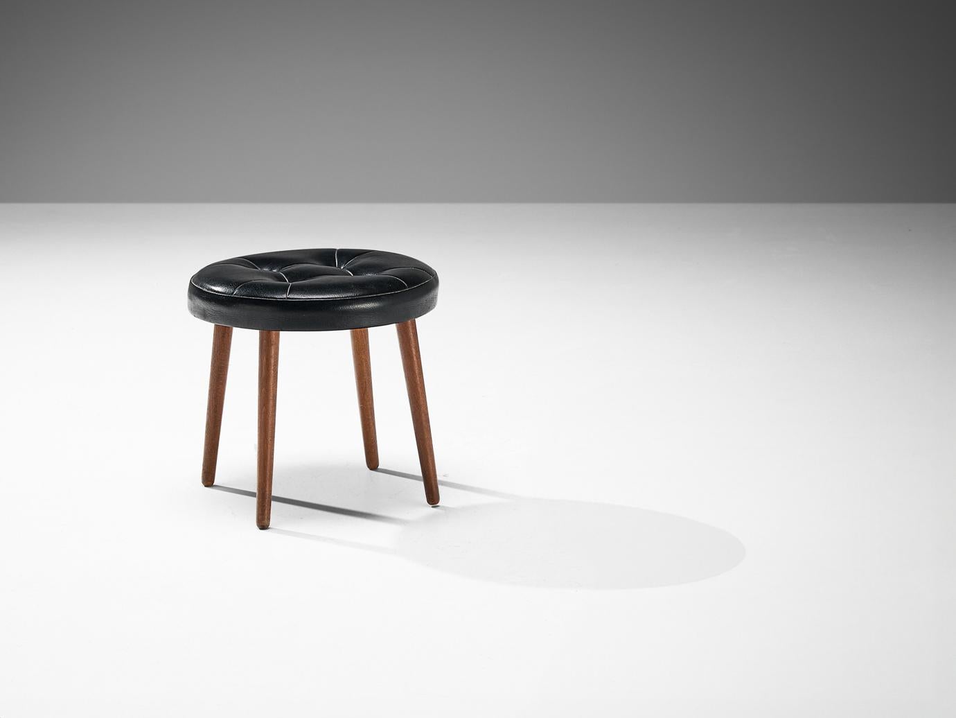 Stool, teak, leatherette, Denmark, 1960s

A sleek stool made in Denmark in the 1960s. This midcentury modern design is a wonderful addition to any interior, due to its minimalist aesthetic. The stool is equipped with a round, tufted cushion,