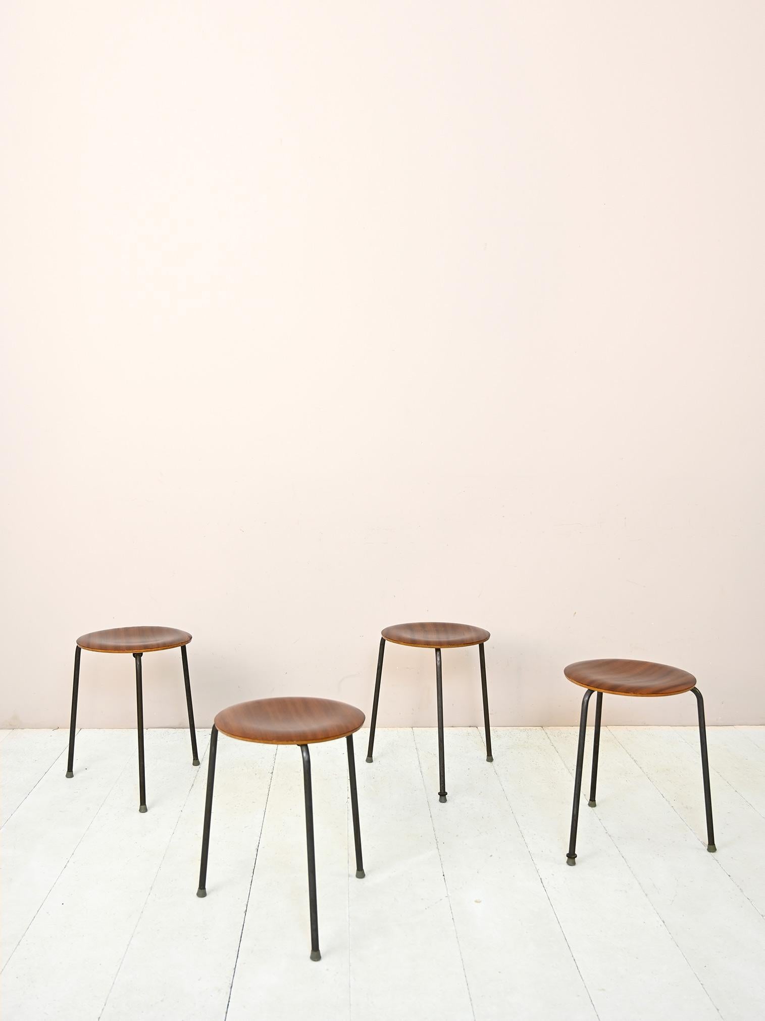Set of 4 original vintage Scandinavian stools.

Featuring simple, minimal lines, they have a tubular metal frame forming the legs and a molded teak wood seat.
Perfect for use as additional seating for guests, but also as nightstands and small