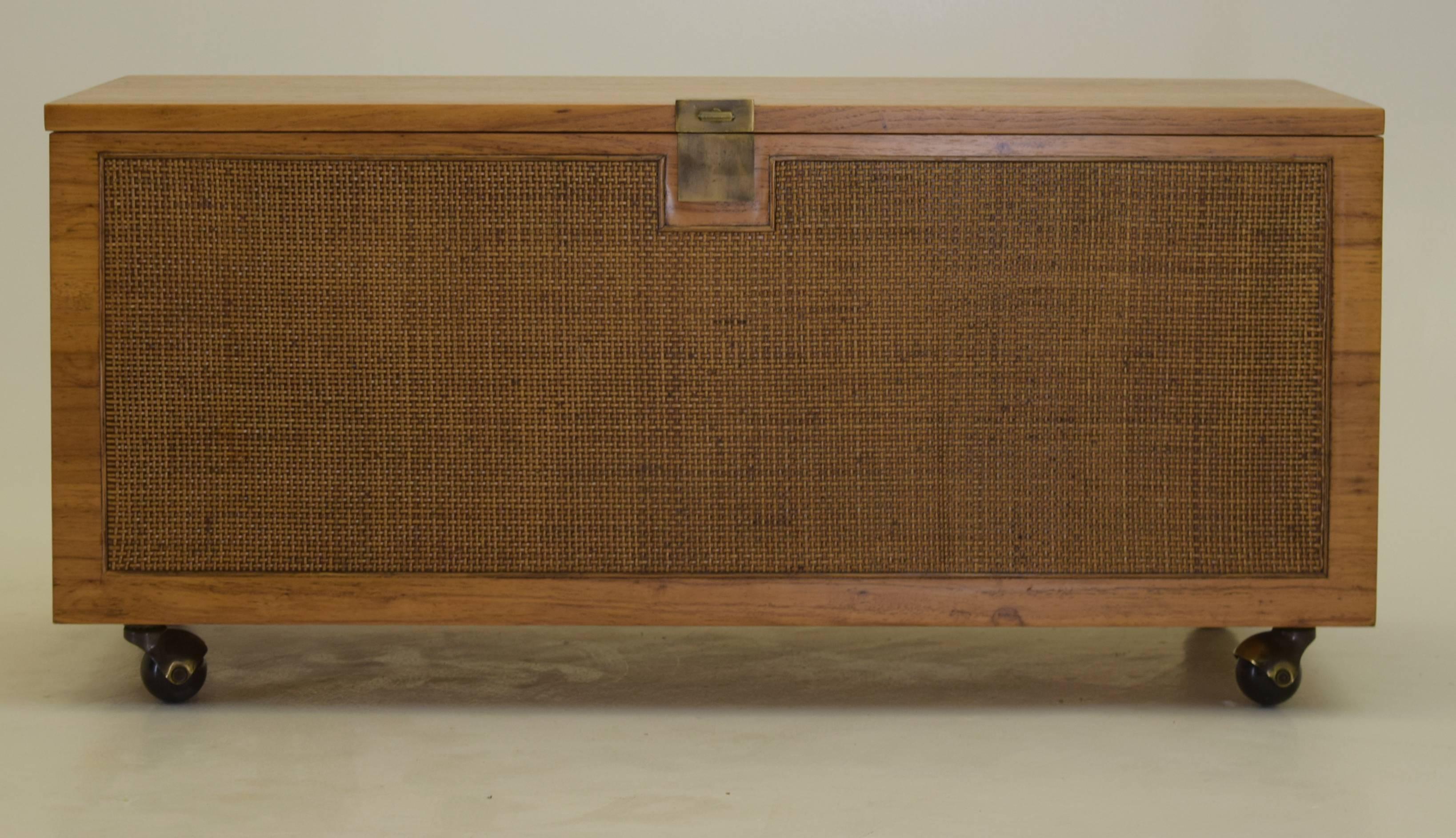 Assumed American Production, but possibly produced in Denmark,
circa 1970
Teak, brass, woven rattan
Measure: 18 tall x 18 deep and 39 inches wide

Storage chests for blankets or bedroom furniture such as this are relatively uncommon for Danish