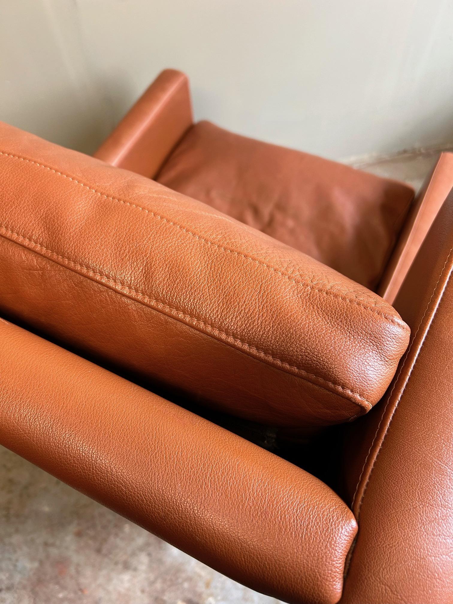 A beautiful Danish tan leather highback armchair by Stouby, this would make a stylish addition to any living or work area.

The chair has a wide seat and padded backrest for enhanced comfort. A striking piece of classic Scandinavian furniture.

The