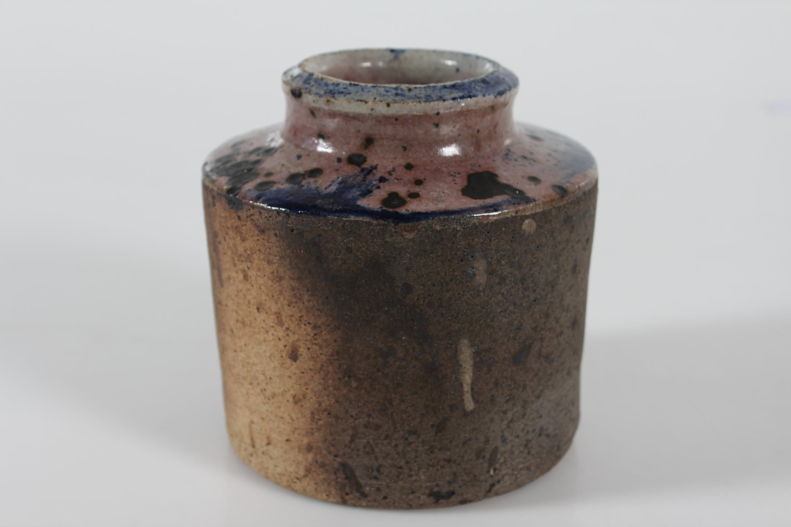 Mid-century stoneware vase by Danish ceramist Chris (Christian Verner) Moes (1914-1998). Made 1972.

The vase features an interesting both matte and glossy surface. The colors are grey, ochre brown and rose with speckles of purple and black. The