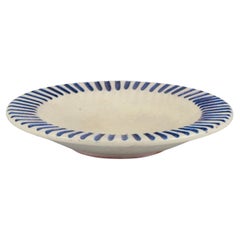 Danish studio ceramicist. Ceramic bowl with fluted design and blue stripes.