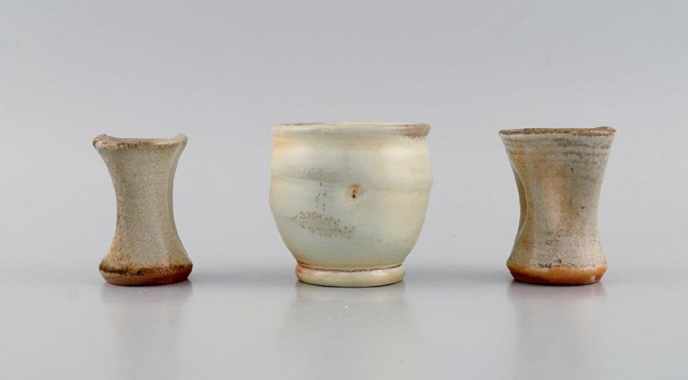 Danish studio ceramicist. Three unique vases in glazed stoneware. 
Beautiful glazes in peach and light earth shades. Late 20th century.
Largest measures: 8 x 7.3 cm.
In excellent condition.
Stamped.