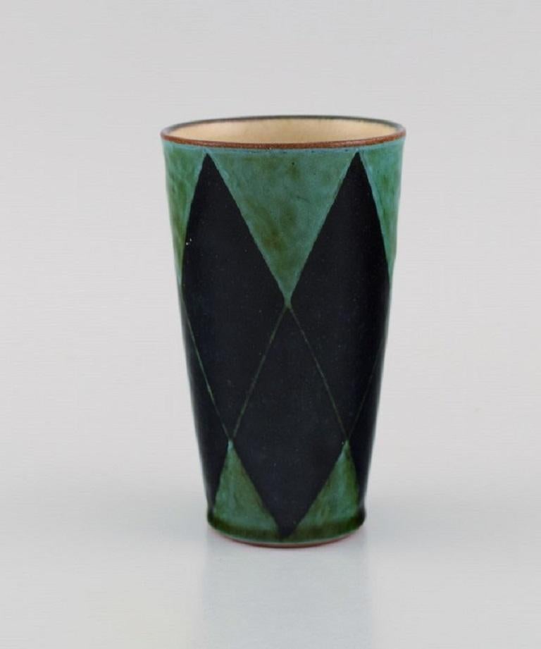 Danish studio ceramicist. Unique vase in glazed stoneware. 
The checkered pattern in black and green shades. Late 20th century.
Measures: 12.5 x 7.3 cm.
In excellent condition.