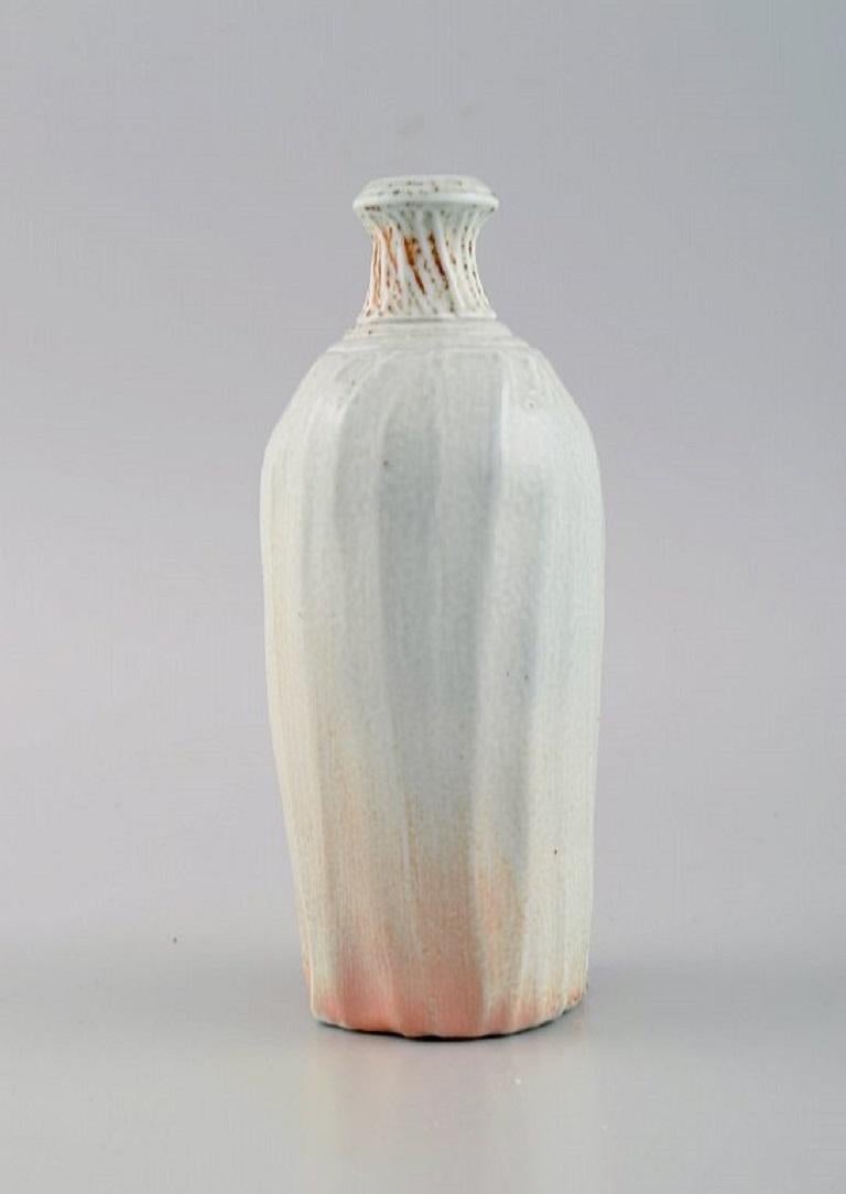 Danish studio ceramicist. Unique vase in glazed stoneware. 
Beautiful glaze in light and orange shades. Late 20th century.
Measures: 15.3 x 6.5 cm.
In excellent condition.
