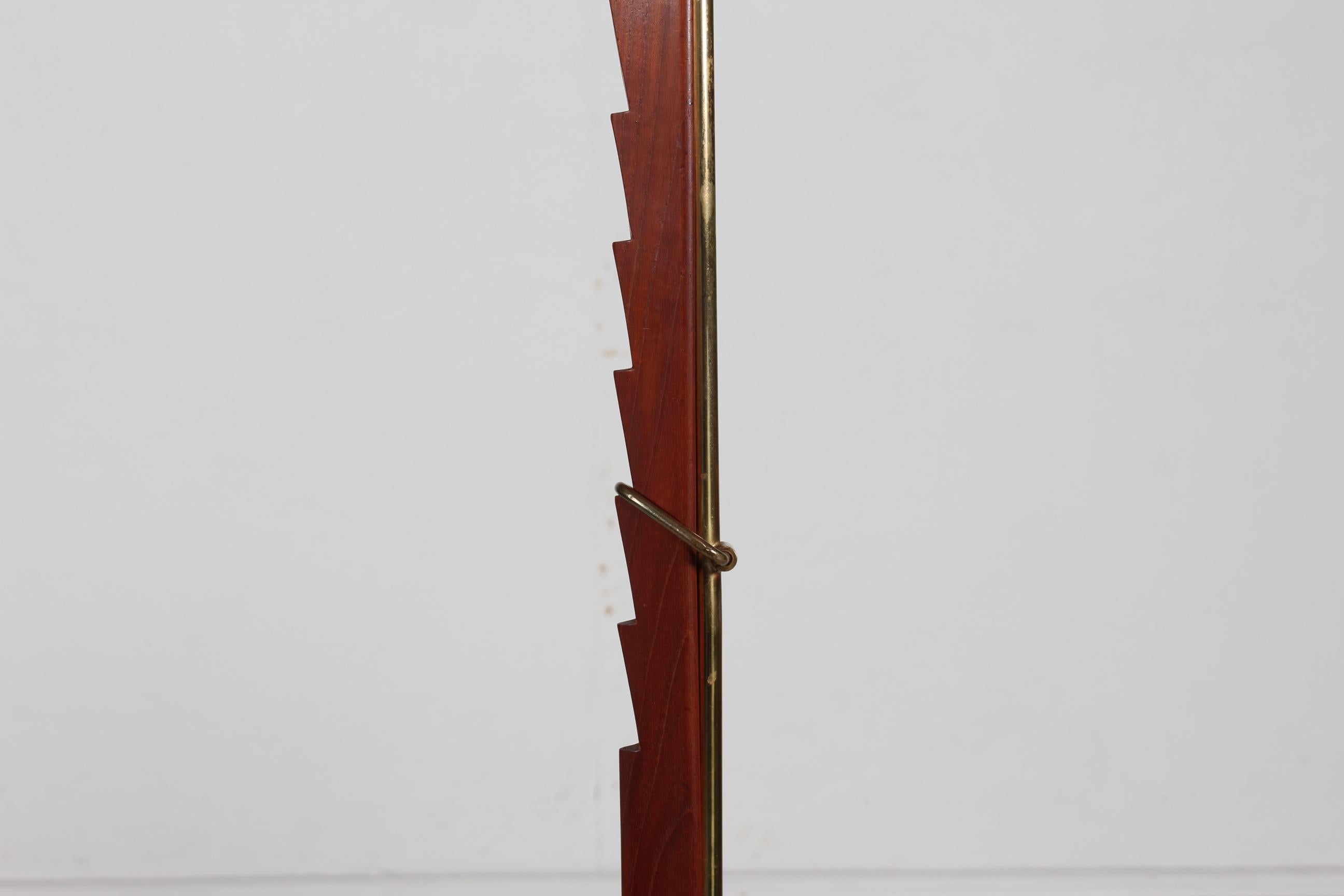 Height adjustable floor lamp by Danish designer Svend Aage Holm Sørensen (1913-2004) made at his own workshop Holm Sørensen & Co.

The lamp base is made of cast iron, the stem is made of teak and brass.
 The lamp shade is a original Le Klint shade