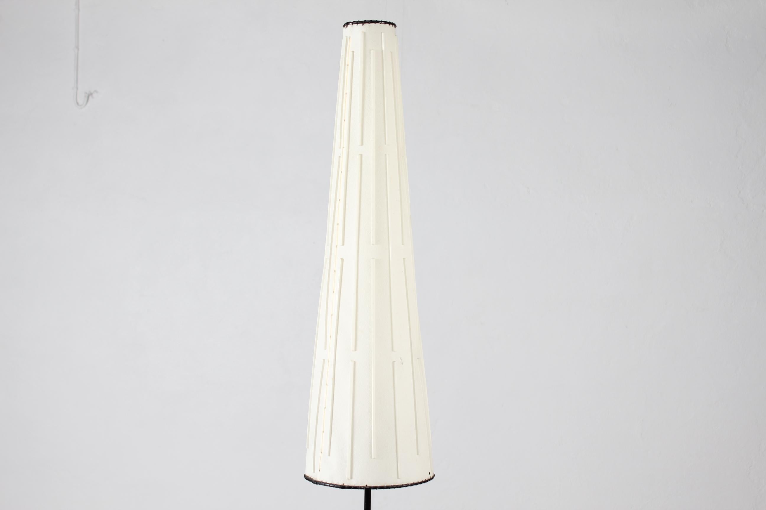 Tall and very slim floor lamp designed by Danish Svend Aage Holm Sørensen (1913-2004). and made at his own workshop.
Slightly tapering conical shade with geometrical decorations in relief. 
The lamp foot is made of cast iron with blue lacquer,