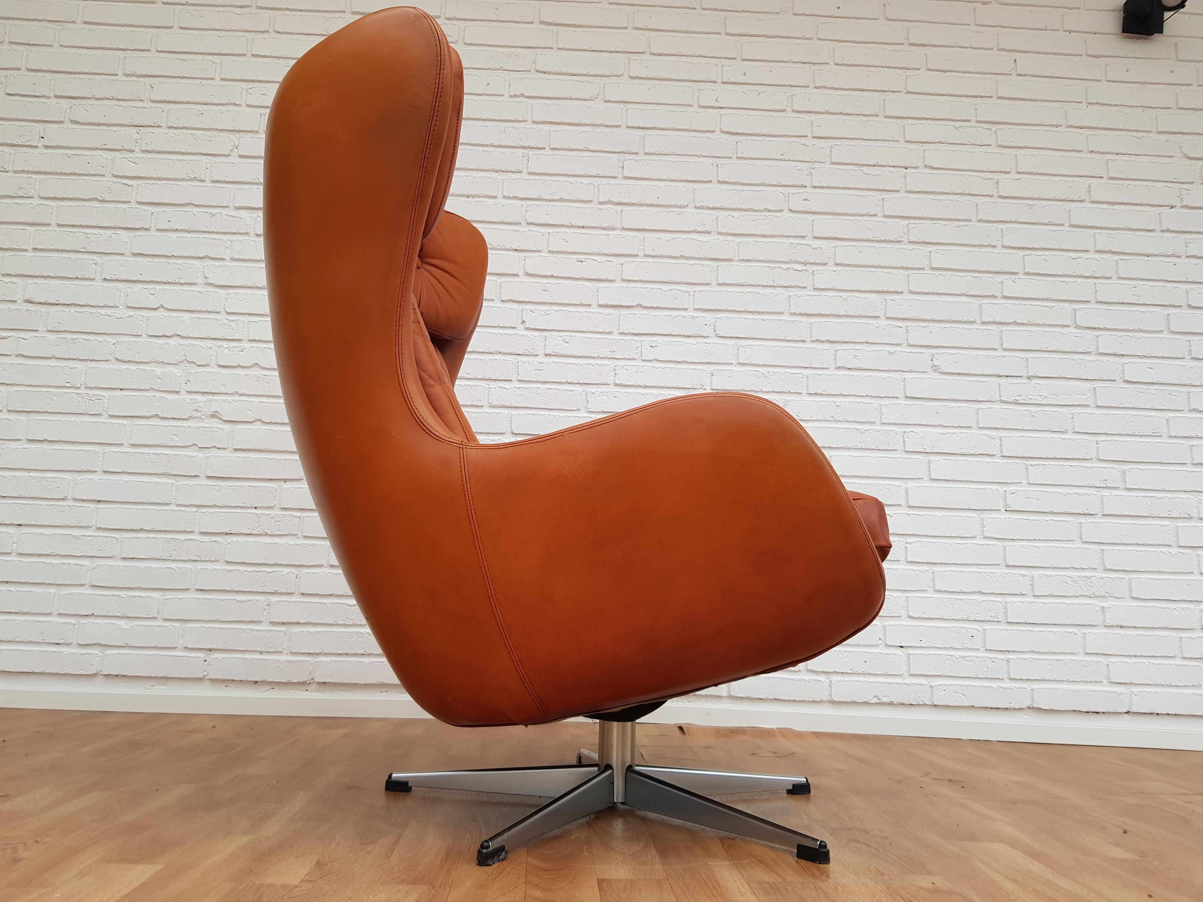 Henry Walter Klein, der dänische Hochlehner-Drehsessel. Der Stuhl ist gebraucht, sauber und erneuert Leder. Loungesessel, gepolstert mit patiniertem cognacbraunem Leder, drehbarer Mittelfuß mit Fünf-Finger-Metallfuß. Sehr gut und bequem zu