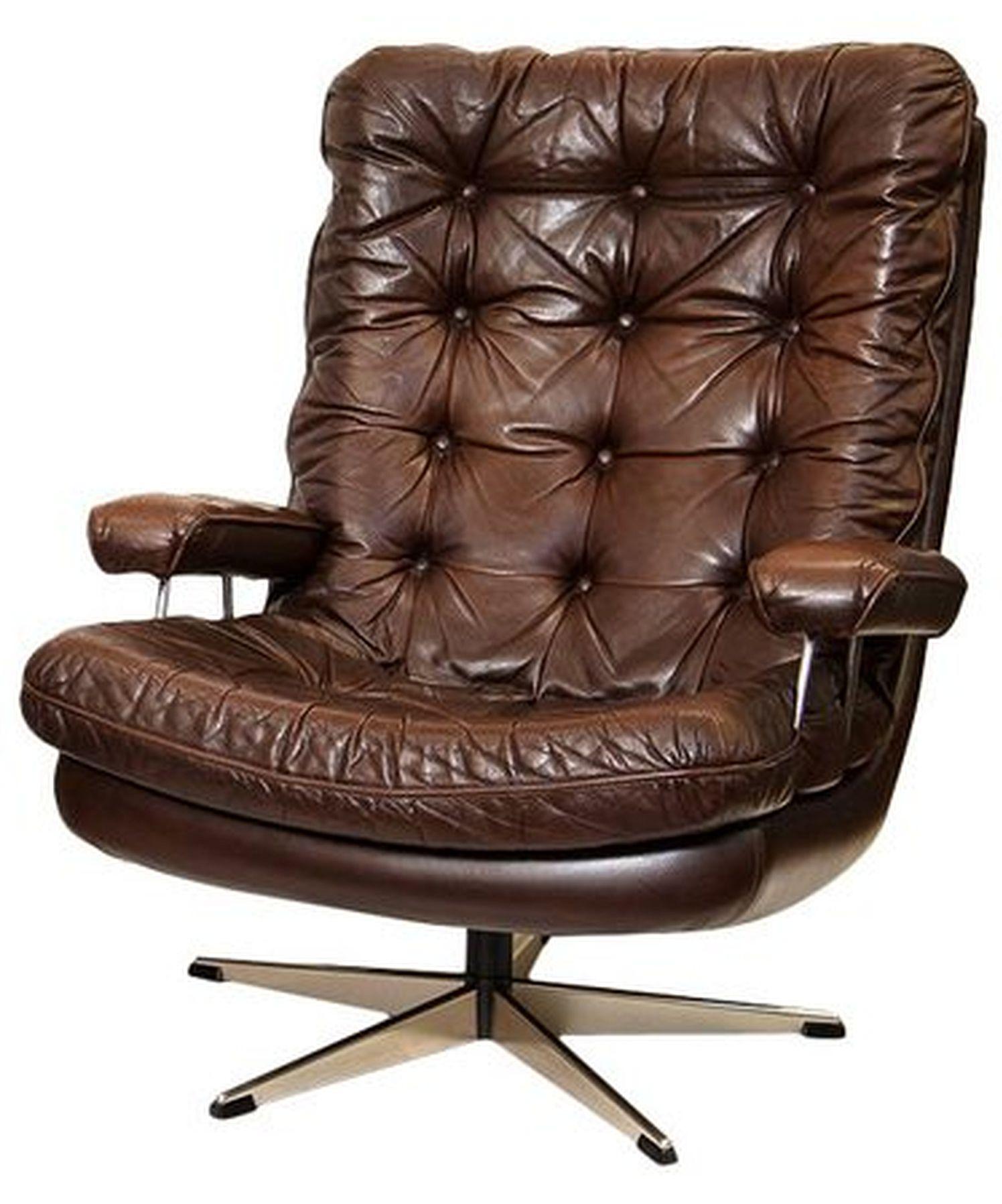 A handsome Danish swivel lounge chair of tufted leather sitting on a five star chrome swivel base. The leather has a good original patination, with a rich chocolate brown color. A very comfortable chair from Denmark, known for quality post war