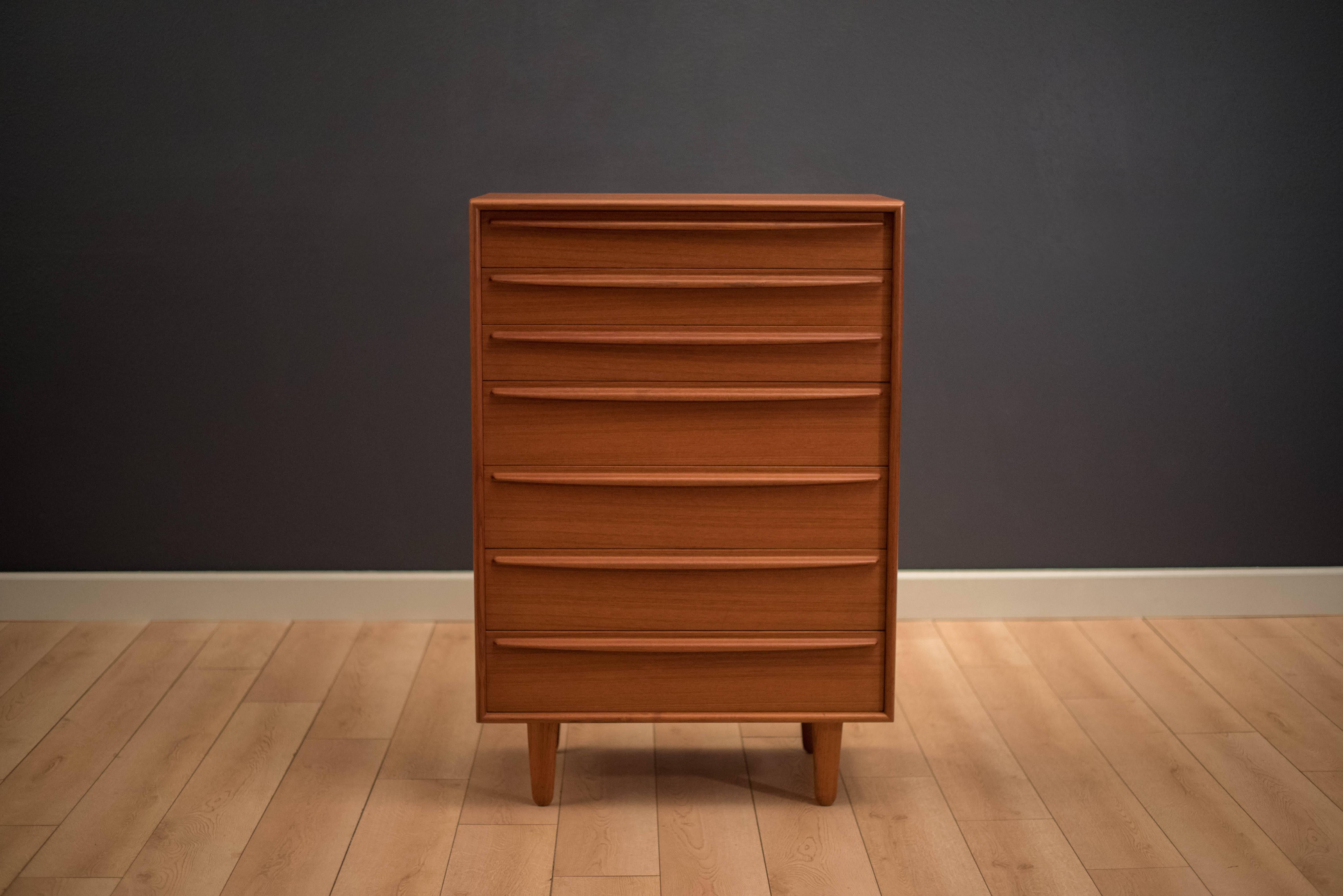 Mid century highboy dresser designed by Svend Madsen in teak. This piece includes seven dovetailed drawers with long sculpted handles.