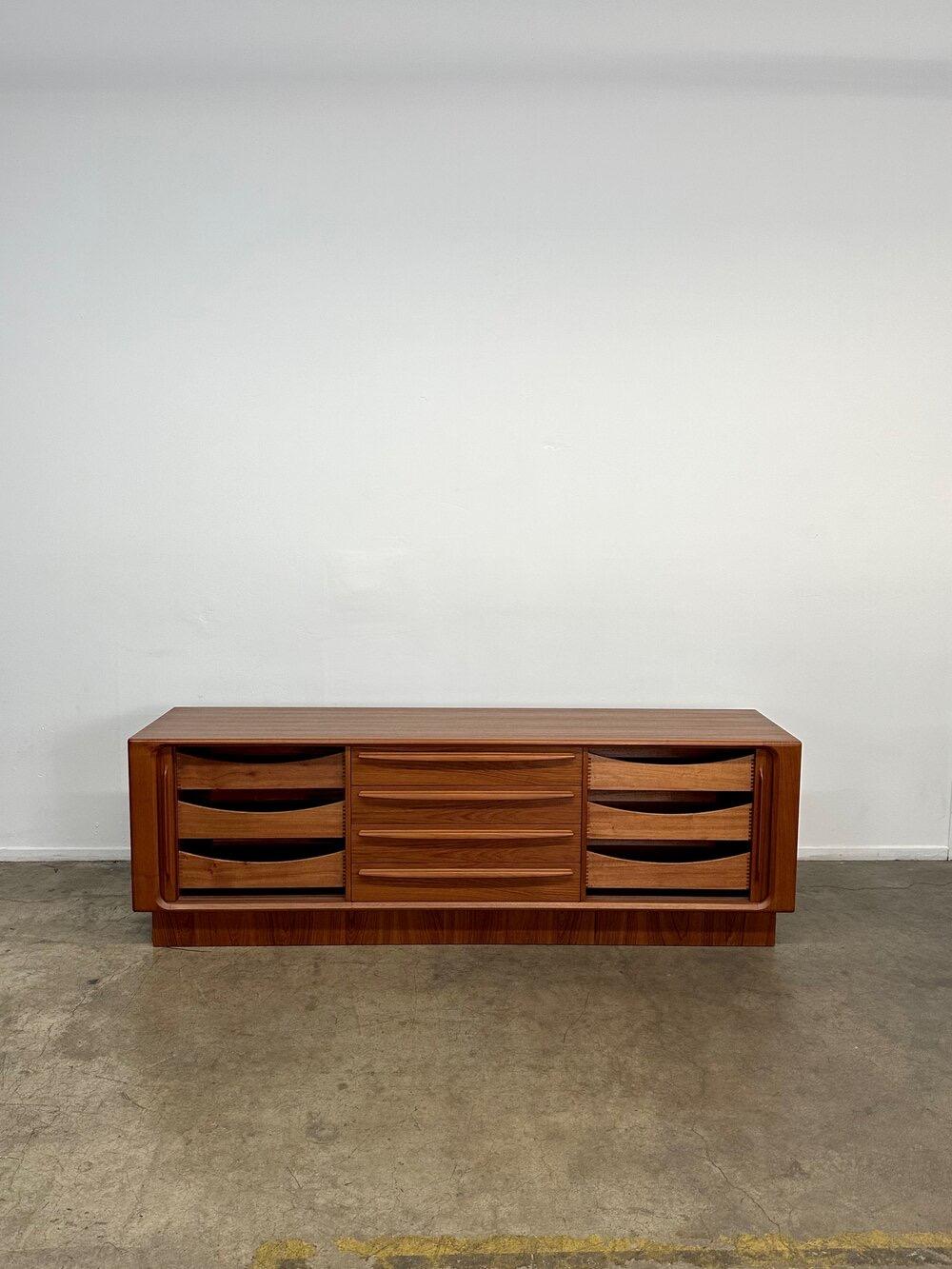 Structurally sound and sturdy teak tambour credenza. Item is most likely by Dyrlund but no manufacture tags were found. This credenza was recently refinished by previous owners and shows in excellent condition. Tambour doors and drawers slide smooth.