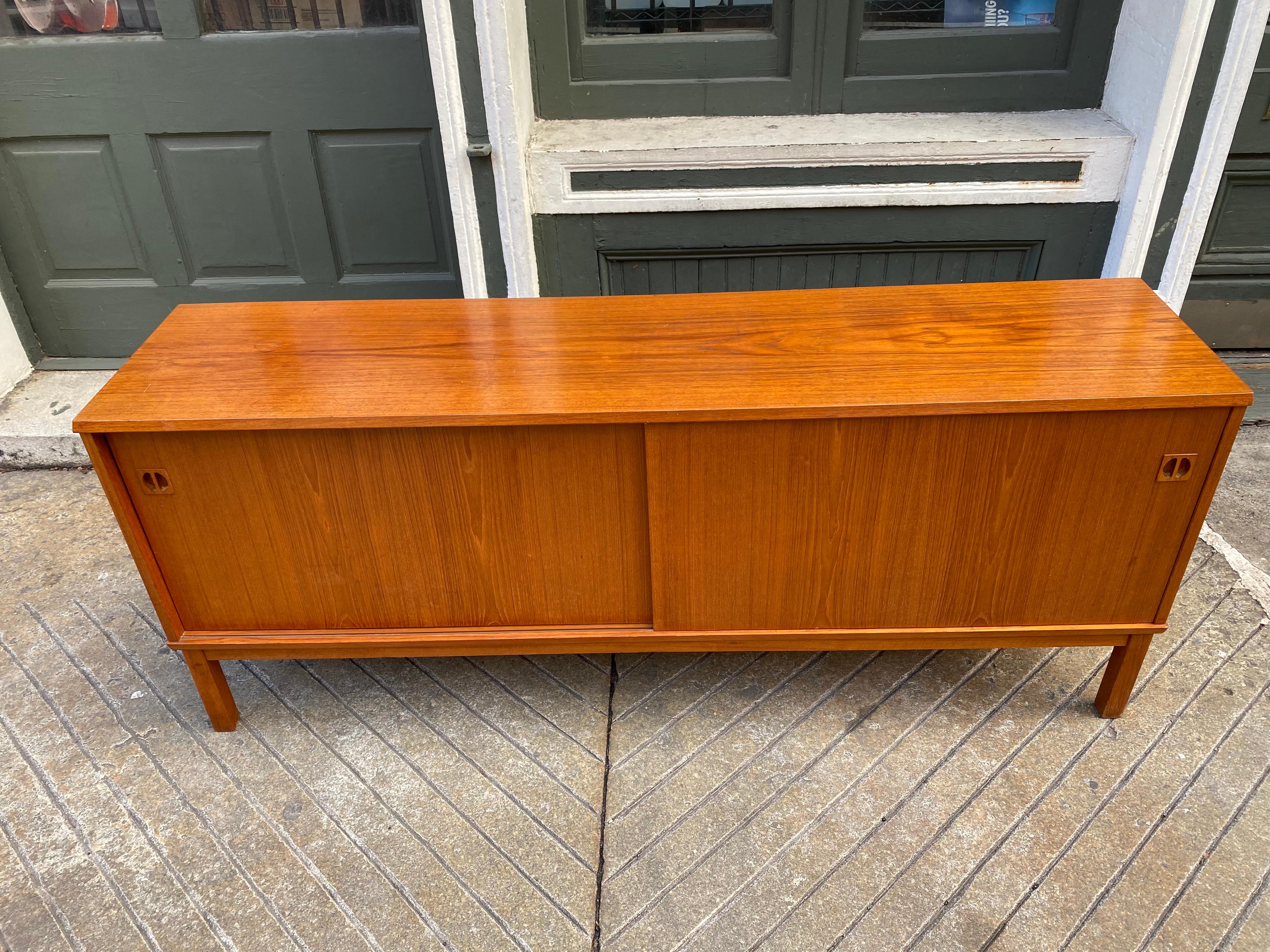 Danish 2-door teak credenza. Nice scale and size! Original finish, shows normal signs of use, see photos for top wear. Overall presents very well! Two small pull out drawers. Measures: 16.5