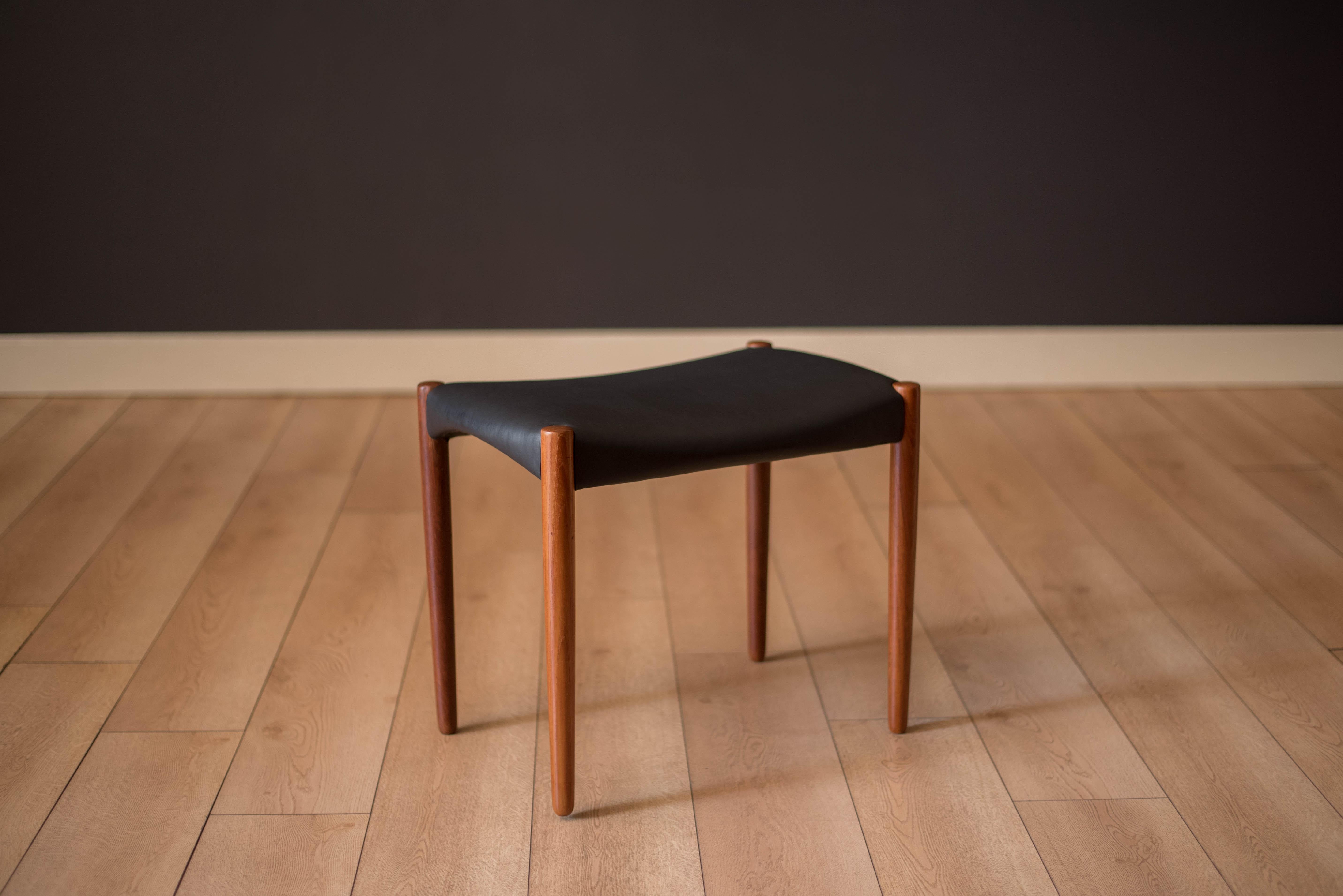 Mid-Century Modern stool in teak by Aksel Bender Madsen and Ejner Larsen for cabinet maker Willy Beck, Denmark. Features a sleek minimalist design and has been newly reupholstered in black leather. This versatile sitting stool can be used as a side