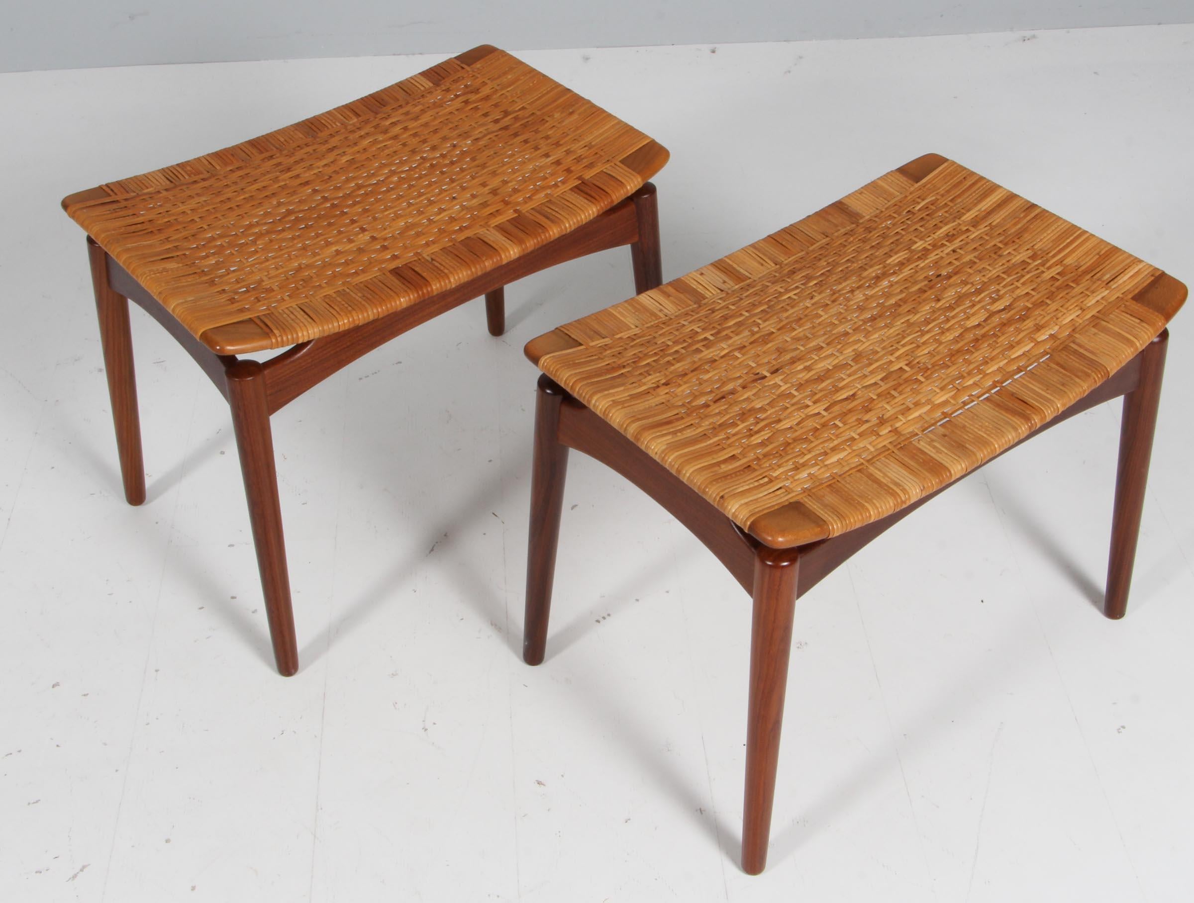 Danish teak and cane pair of  stools from Ølholm Møbelfabrik, 1950s
Designed by Sigfred Omann for Ølholm Møbelfabrik, Denmark in the 1950s.
Stylish and elegant Mid-Century Modern footstool in solid teak with cane seat. Round tapered legs and curved