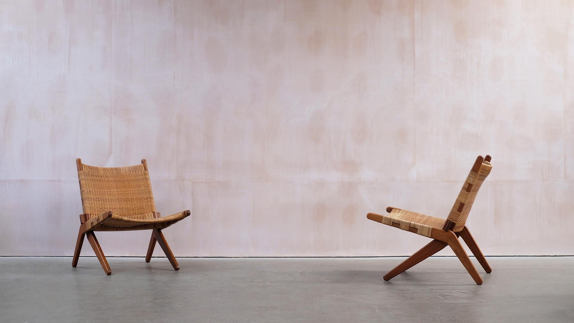 Amazing pair of Danish Scissor lounge chairs in beautiful teak and cane possibly designed by Preben Thorsen for Soro Mobelfabrik. Originally bought in 1961, these chairs are super high quality and a very interesting design. They are comfortable and