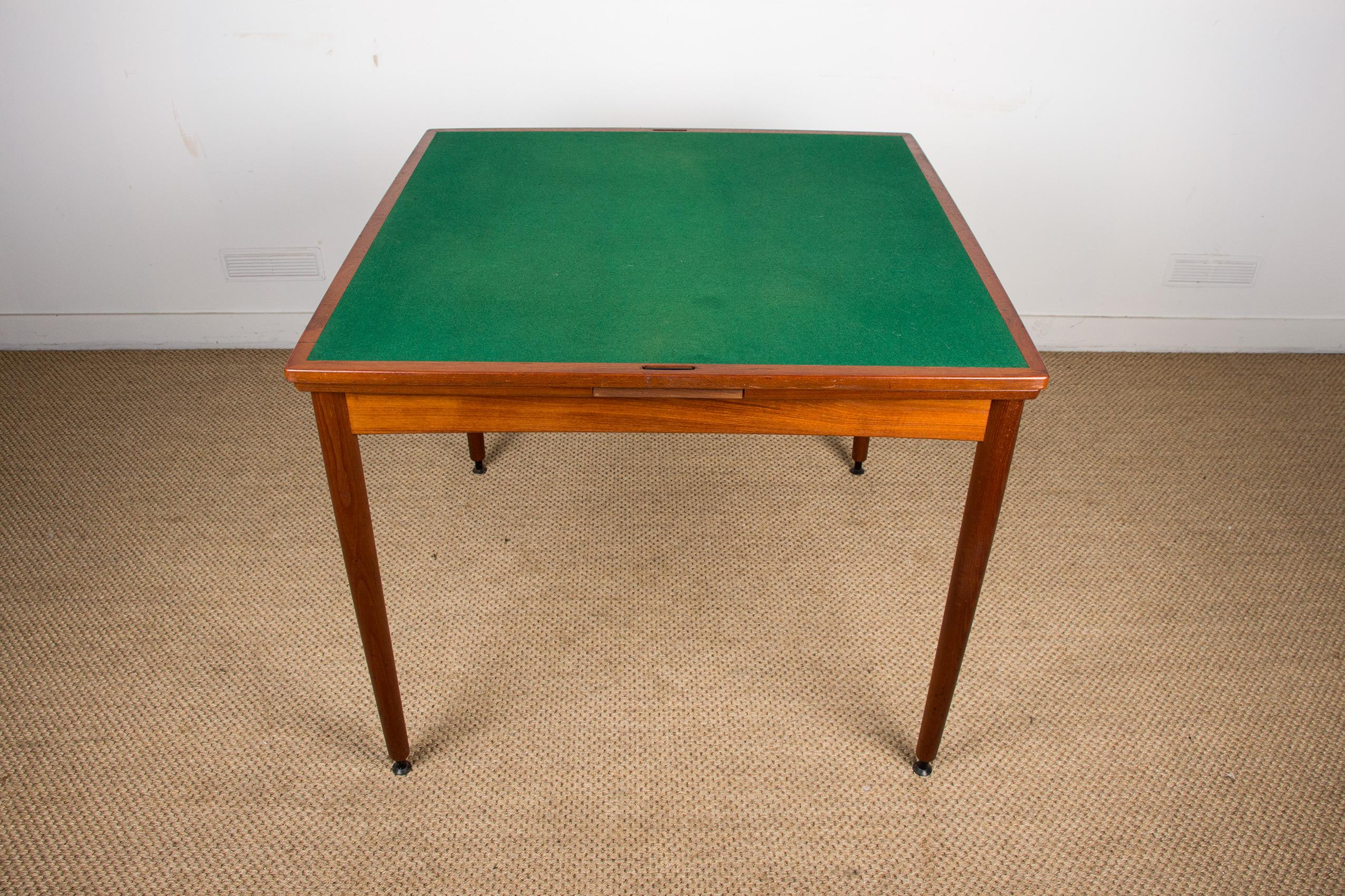 Preciosa mesa escandinava muy funcional. La parte superior es reversible, con un lado de fieltro para jugar y otro de teca. Dos hojas extensibles pueden guardarse discretamente debajo de la mesa. Polivalente para el salón o la cocina, ideal para