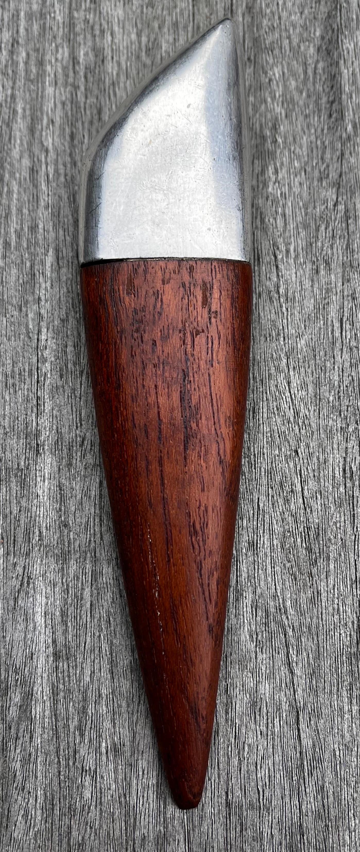 Teak and Metal Bottle Opener
Denmark, circa 1950

Inscribed Mark: PJO (PJ Ostergaard) Denmark 

