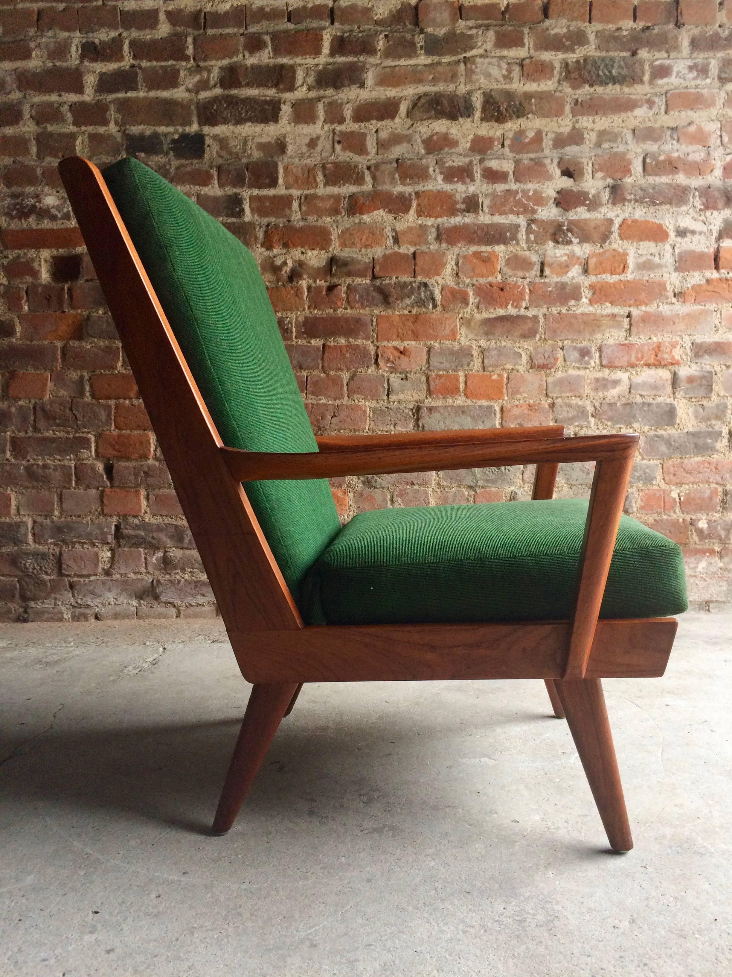 A beautiful midcentury Danish teak armchair circa 1950s, good clean lines with a low teak frame with removable original green cushions with sprung base, the chair is in good original condition with only light wear and extremely