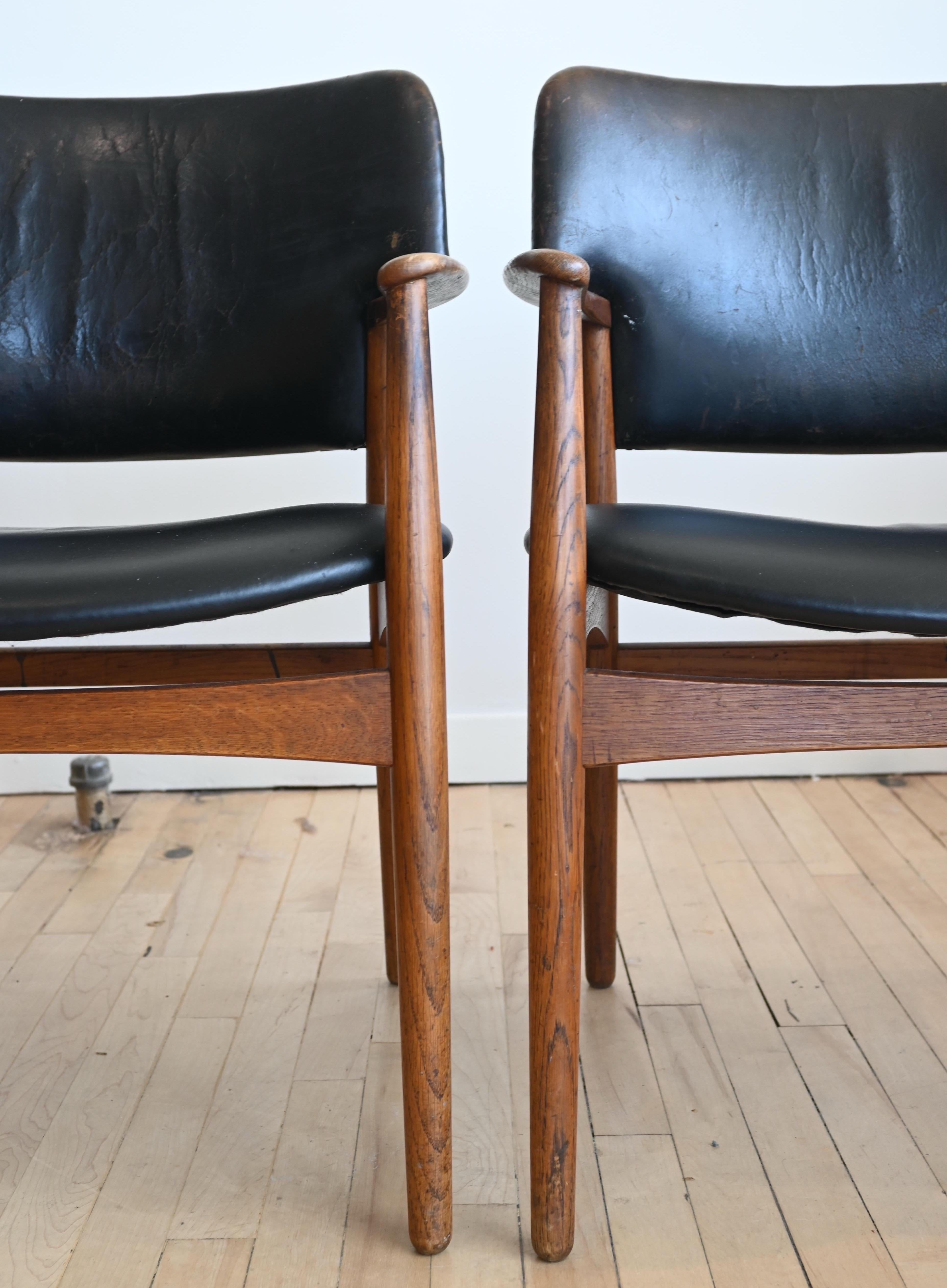 A pair of Teak Dining Armchairs from Denmark. Beautiful worn leather and patinated teak. Sturdy shape and design. 