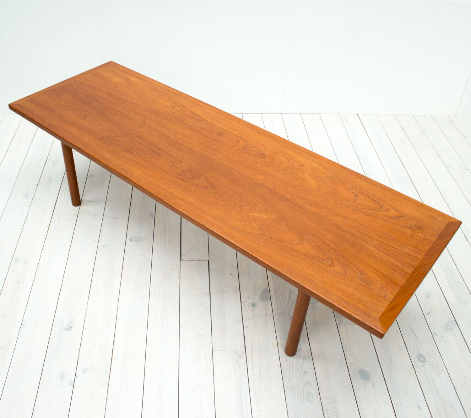1960s Danish teak model AT-12 coffee table by Hans J. Wegner for Andreas Tuck. A lovely minimalist piece with a long rectangular top on turned legs. The legs unscrew making this item easy to flat pack and ship.

