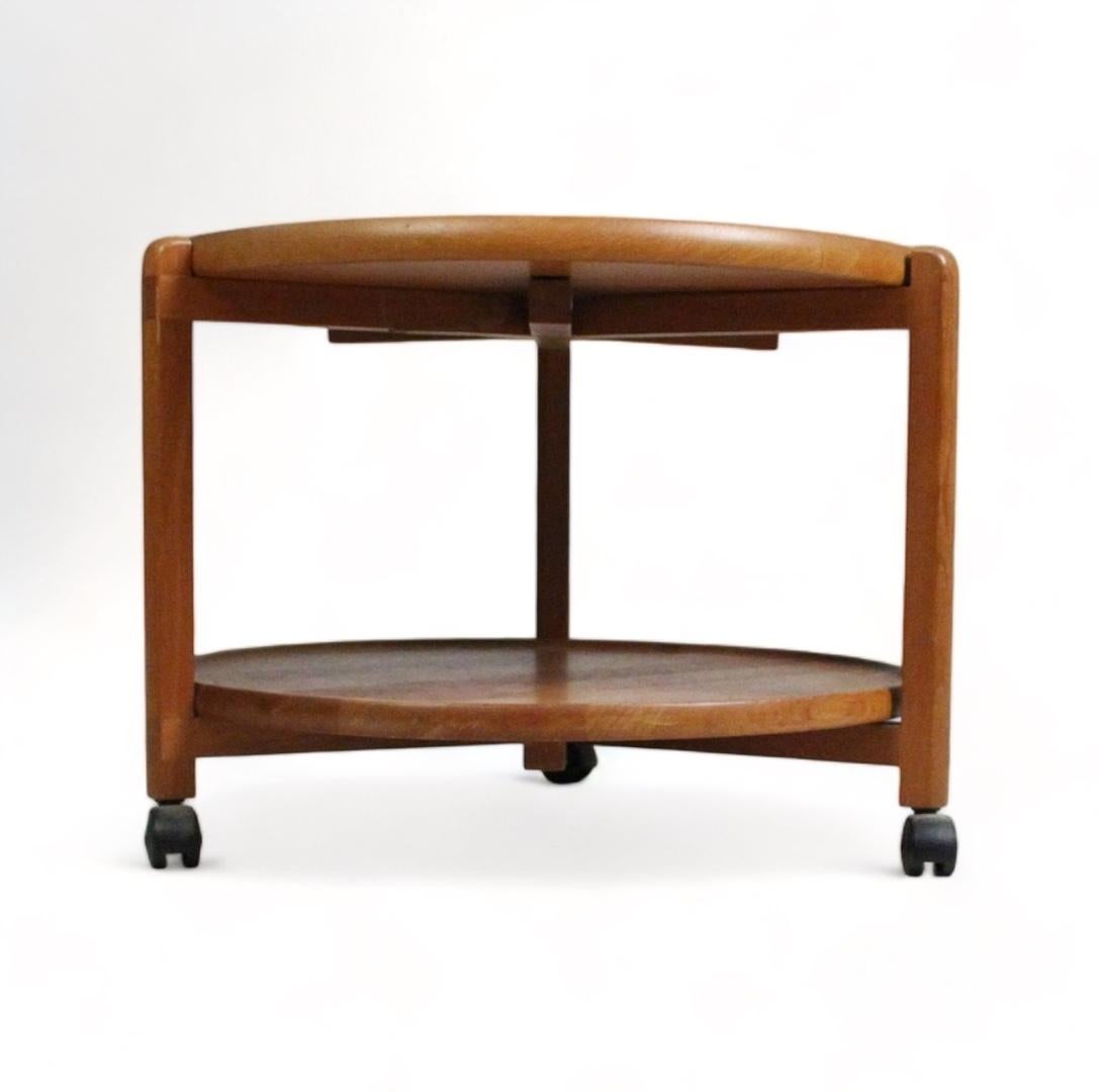 The 1960 Danish teak table is an iconic piece that fuses elegance and functionality in its timeless design. Crafted from rich, warm teak wood, this table exudes a natural charm and beauty that endures over time.

With its removable top tray, the