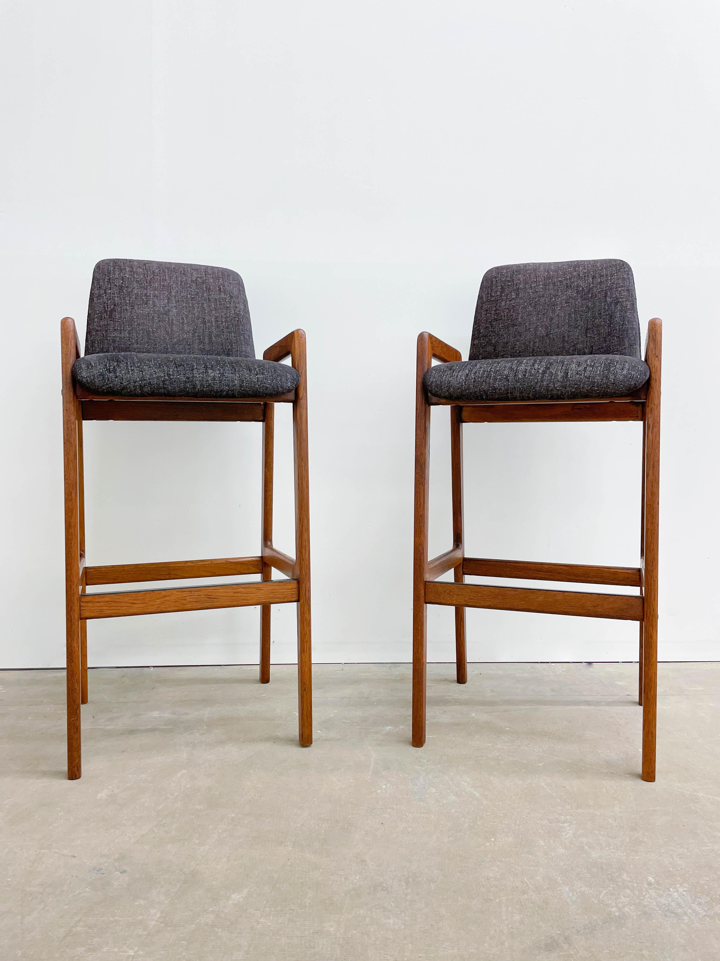 Classic Danish modern design by Tarm Stole OG Mobelfabrik made from solid teak with form fitting seats. Sturdy construction, beautiful teak woodgrain and stylish dark gray upholstery combine to make a pair of very mocfortable and practical