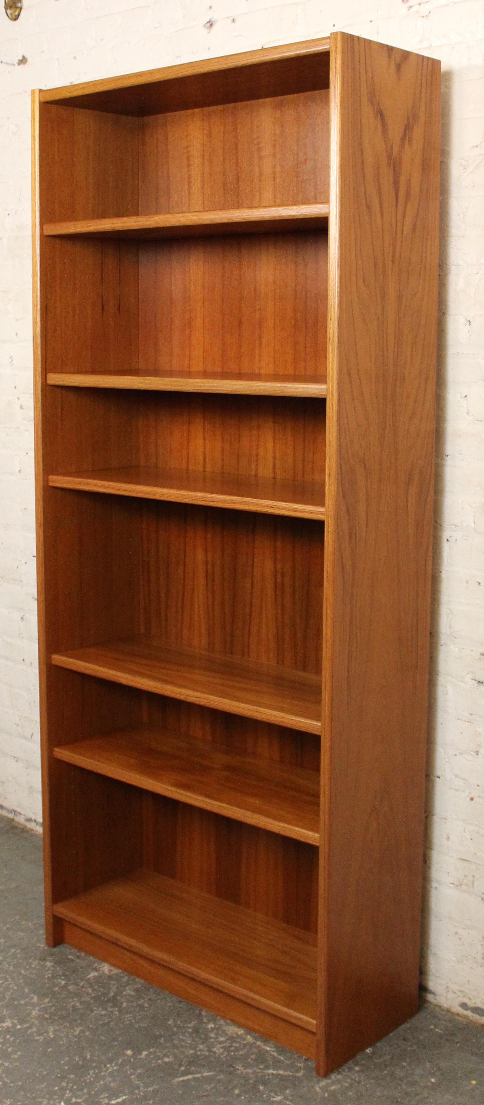 Tall Danish modern teak bookcase by Uldum Møbelfabrik, standing over 6 feet high. Features clean lines with multiple adjustable shelves, offering versatile storage and display. A refined example of mid-century Scandinavian craftsmanship.

Please