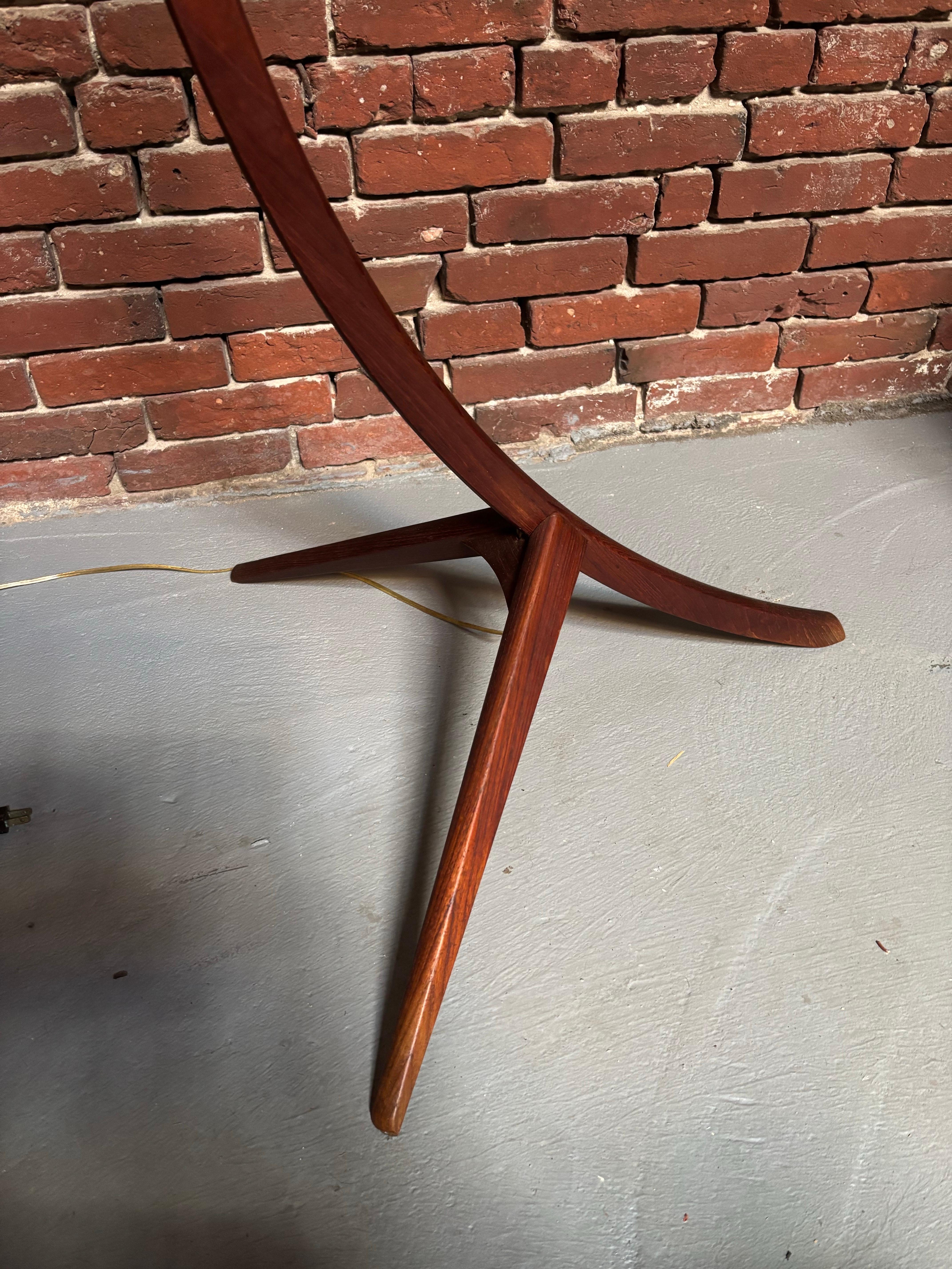 Danish Arc or Bow Teak Floor Lamp with cane wrapped center. Newly rewired and ready to go! Lampshade adjusts so you can adjust angle of light. Pull Chain Switch adds a little style and ease when turning on and off! Unique Lamp that will add