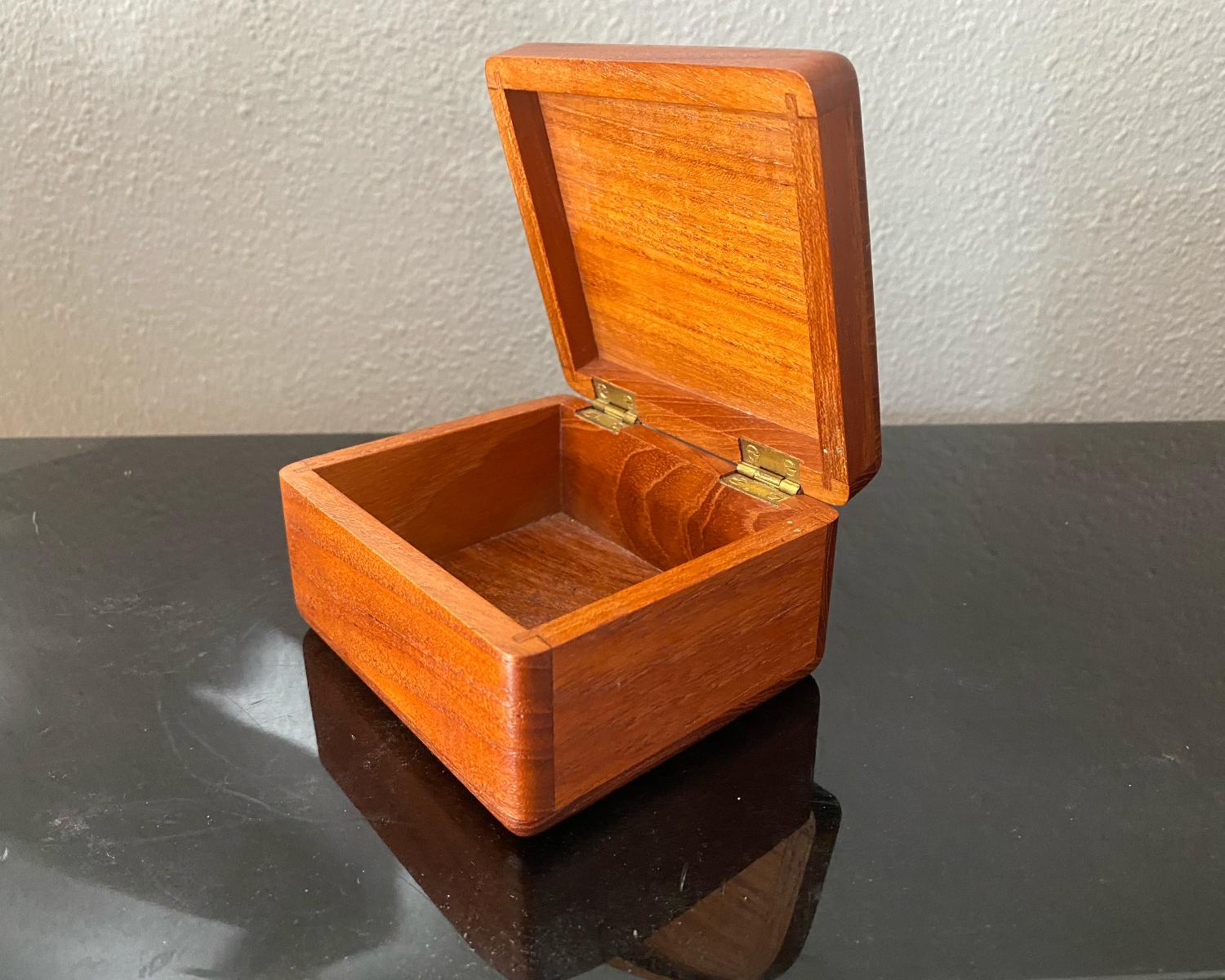 This is a small but perfectly made teak wooden box, made in Denmark.