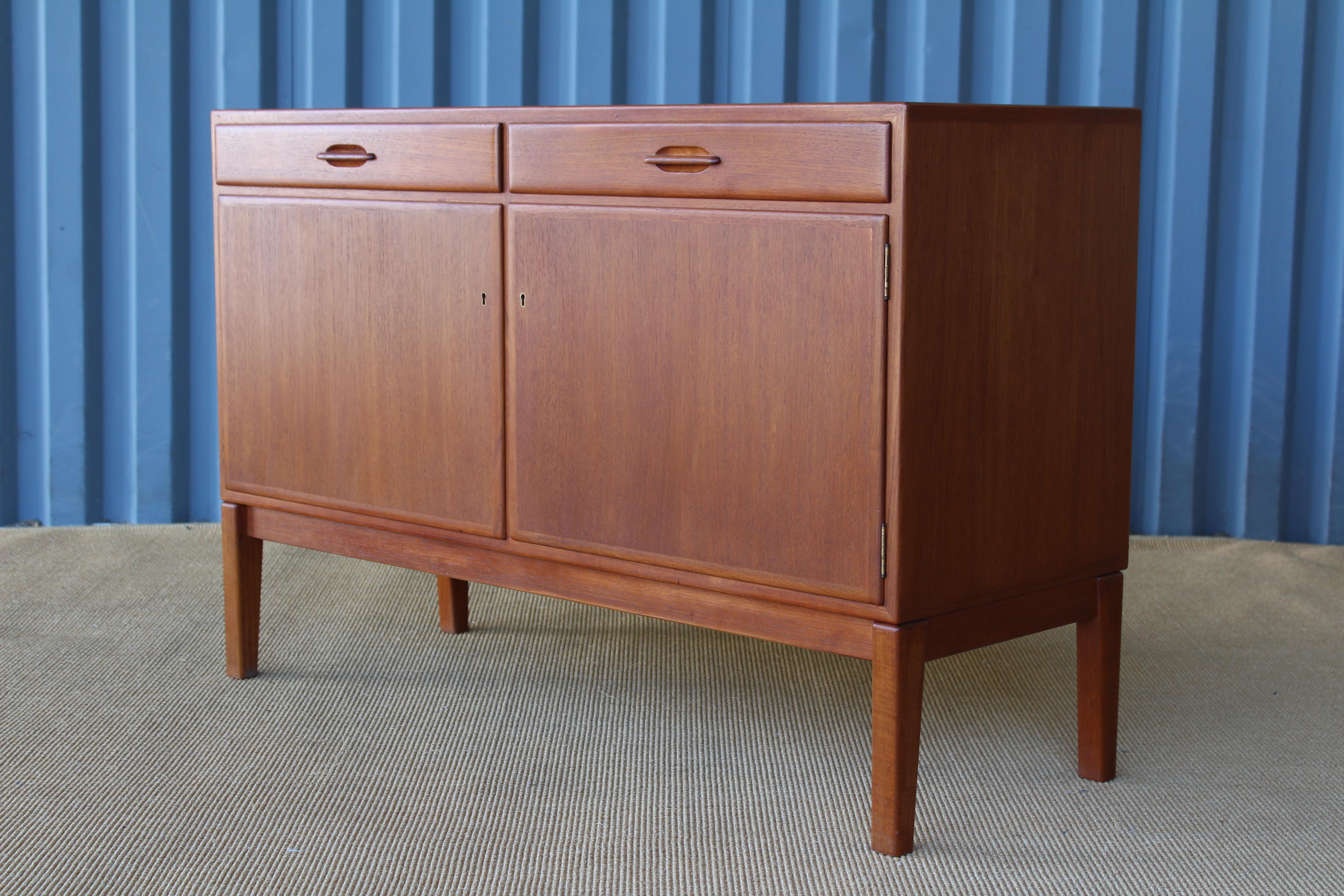 Pair of newly refinished Danish teak cabinets with beautiful maple interiors. Each cabinet features two locking doors and two dovetail drawers. Pair available, sold individually.
 