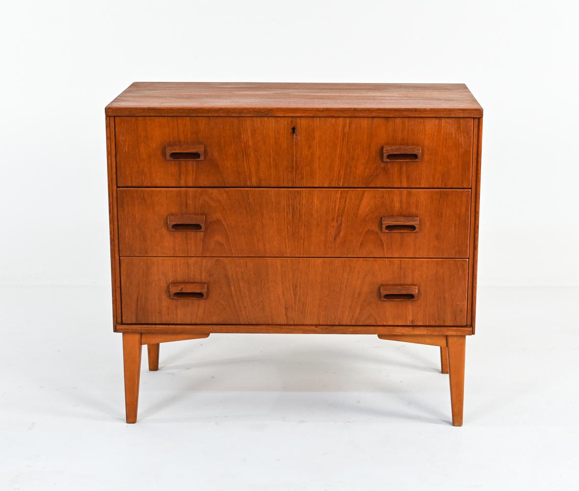 This petite chest is ideal for an apartment dweller or anyone looking for a little extra storage! Featuring three dovetailed drawers with sculpted wood handles, this chest cuts a timeless Mid-Century silhouette with tapered braced legs. The exterior